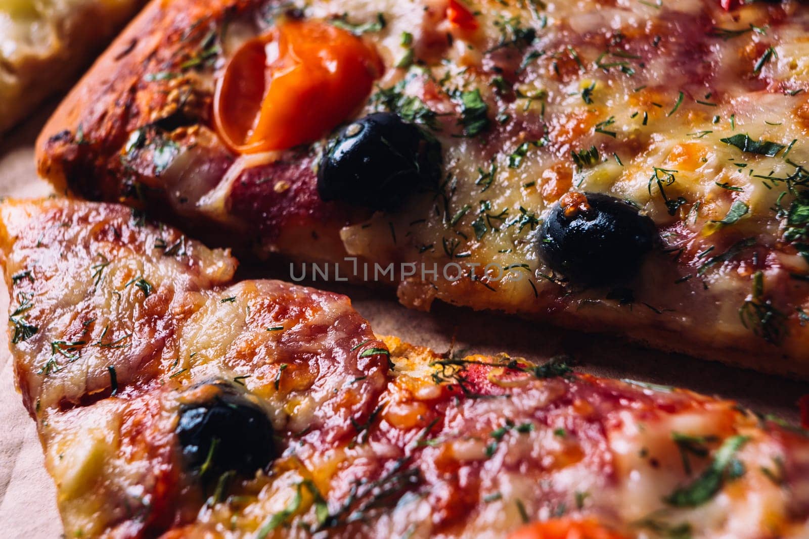 pieces of pizza with olives, cheese and salami sausage