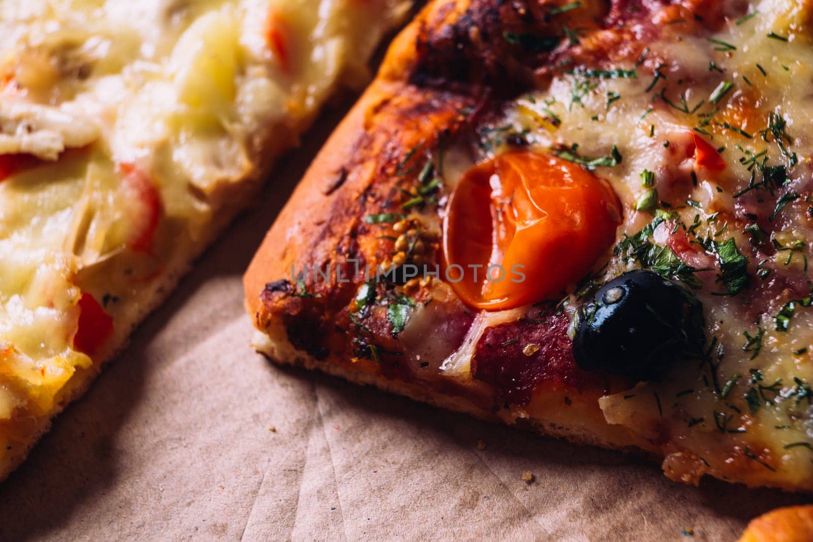 pieces of pizza with olives, cheese and salami sausage