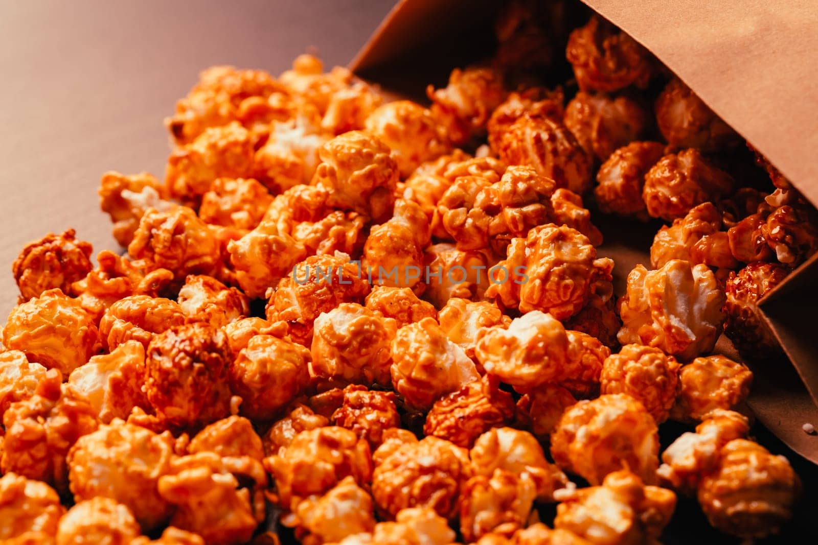 many popcorn in a paper bag on a dark background