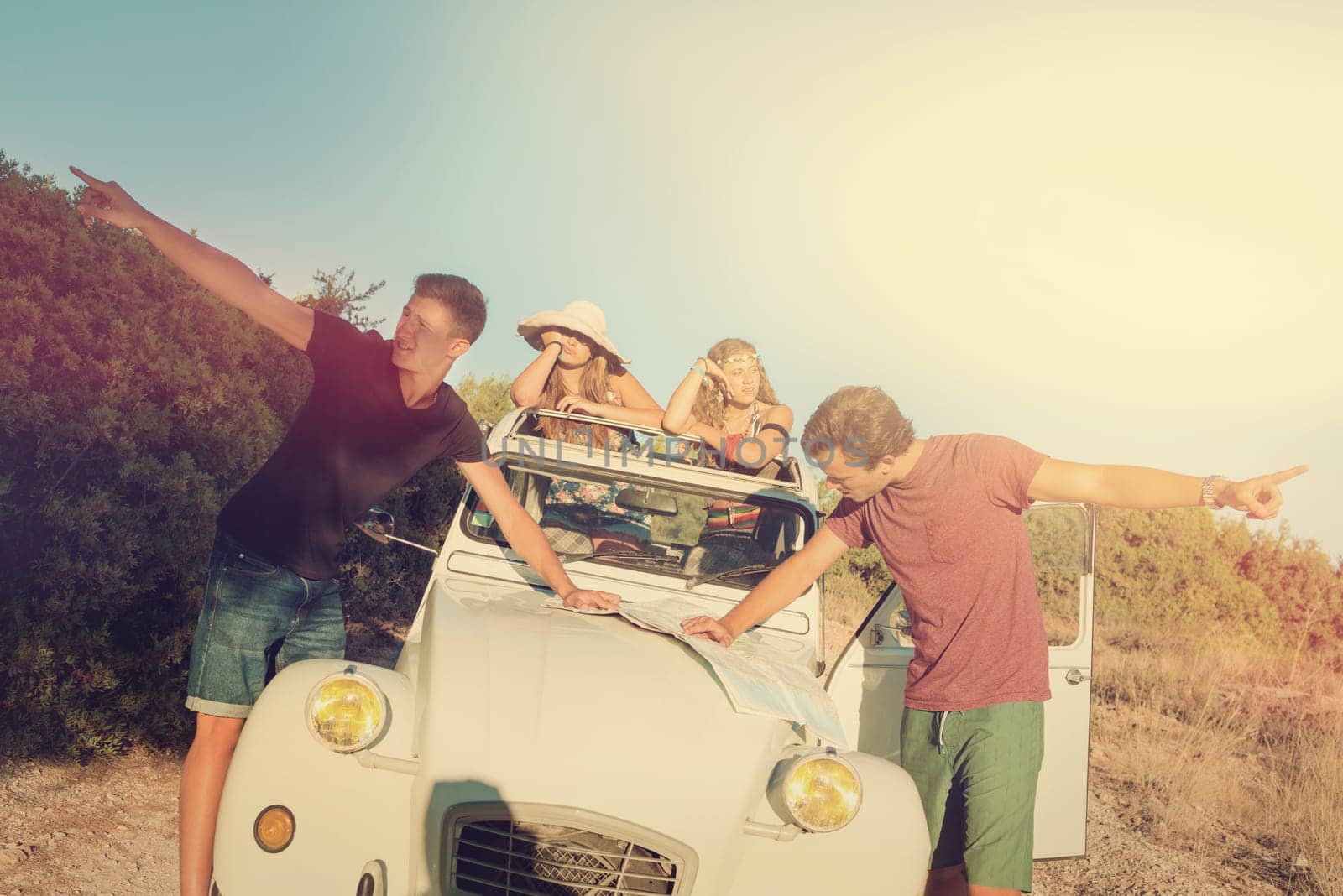 Vintage style image of boys with a map fighting over directions, and girls waiting in the car.