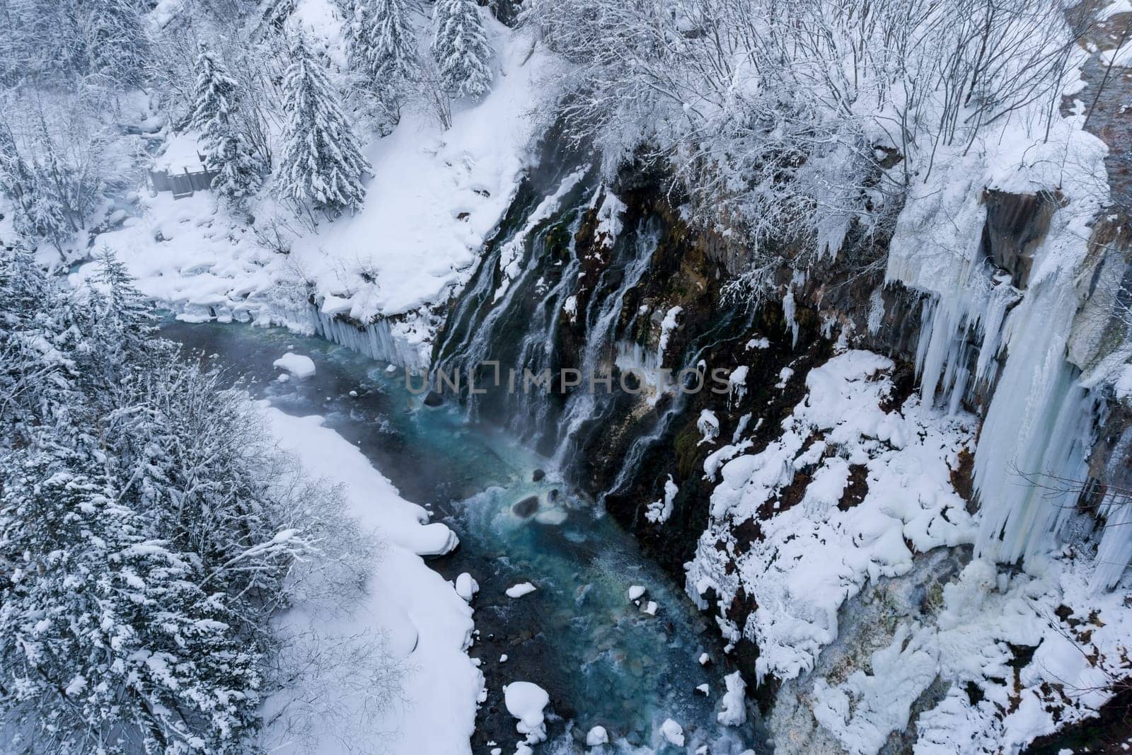 shirahige waterfall located 600 meters above sea leven in the Shirogane hot spring village of Biei City, this waterfall stands more than 30 meters tall. The water flowing down the gaps between the rocks resembles a white beard.