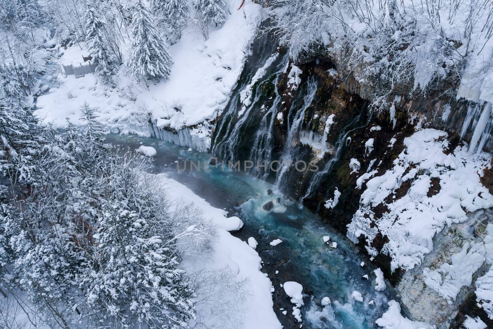 shirahige waterfall located 600 meters above sea leven in the Shirogane hot spring village of Biei City, this waterfall stands more than 30 meters tall. The water flowing down the gaps between the rocks resembles a white beard.