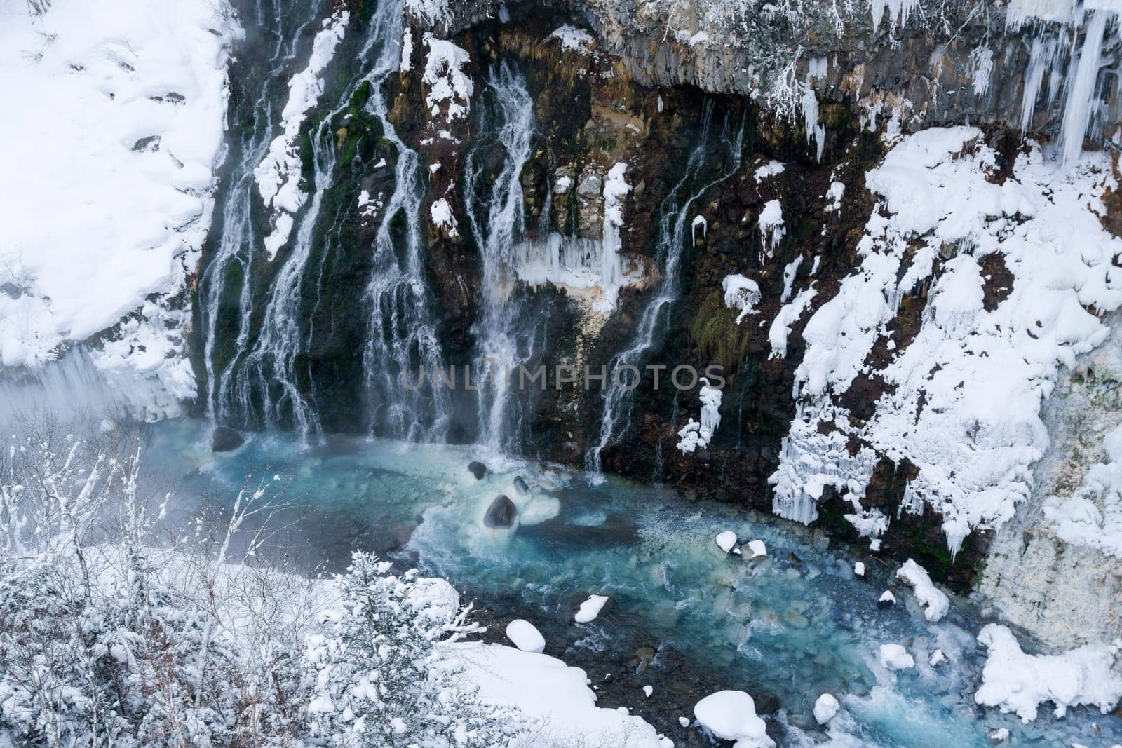 shirahige waterfall located 600 meters above sea leven in the Shirogane hot spring village of Biei City, this waterfall stands more than 30 meters tall. The water flowing down the gaps between the rocks resembles a white beard.