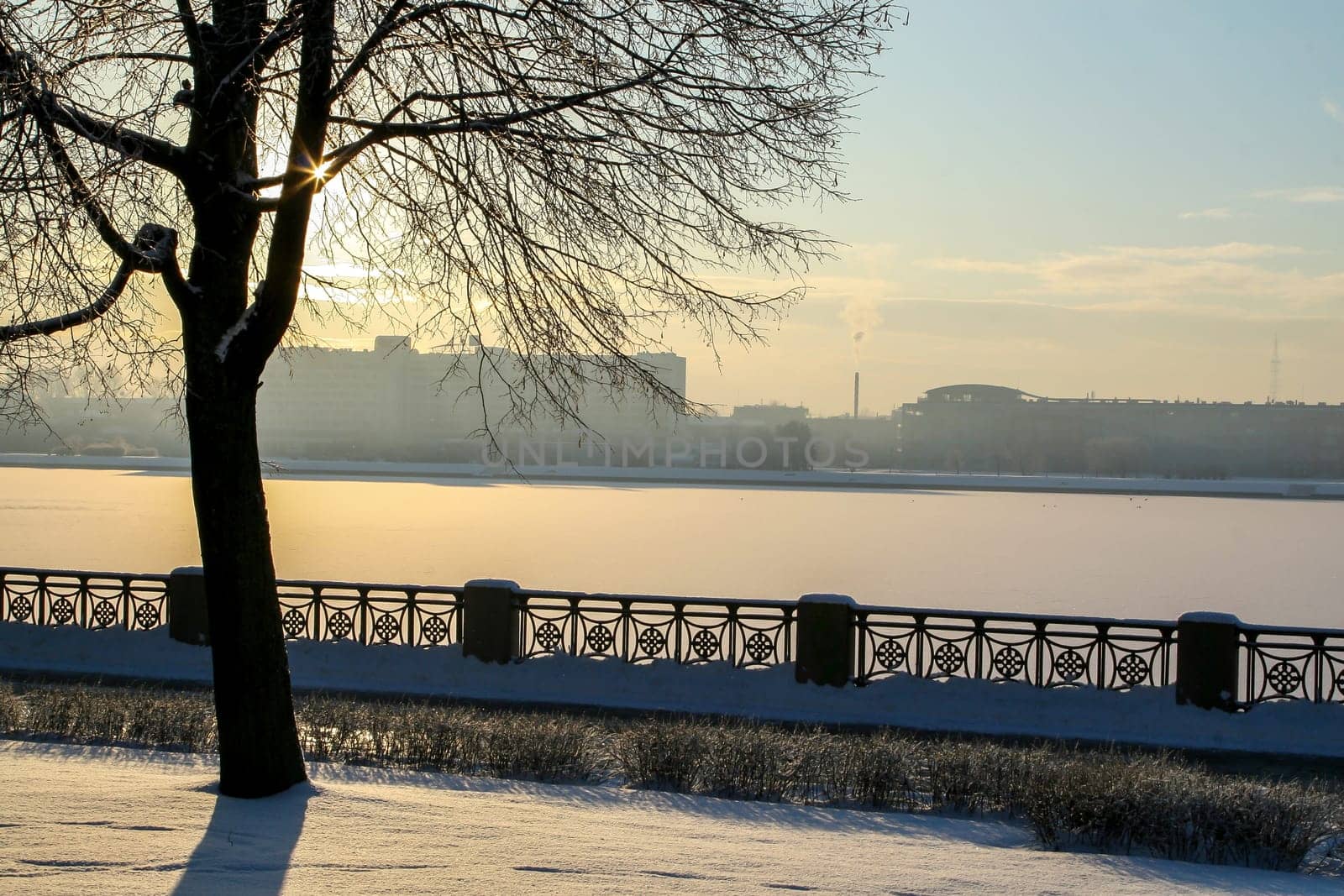 View of Riga from the 11th November Embankment side. Riga view in winter. Frozen river Daugava at the 11th November Embankment.
