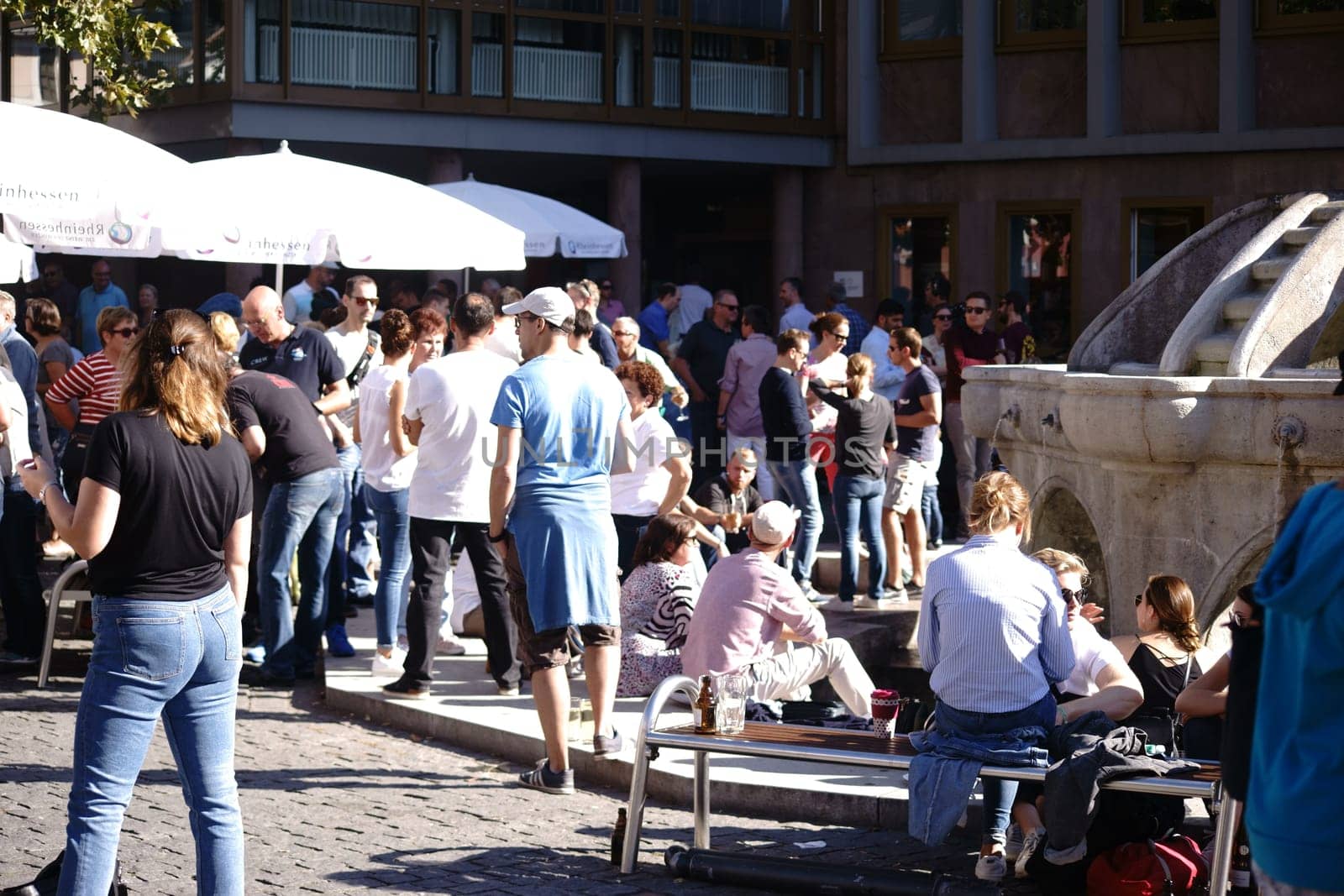 Worms, Germany - October 13, 2018: In fine weather, many people sit at a fountain on the market and drink wine on 13 October 2018 in Worms...
