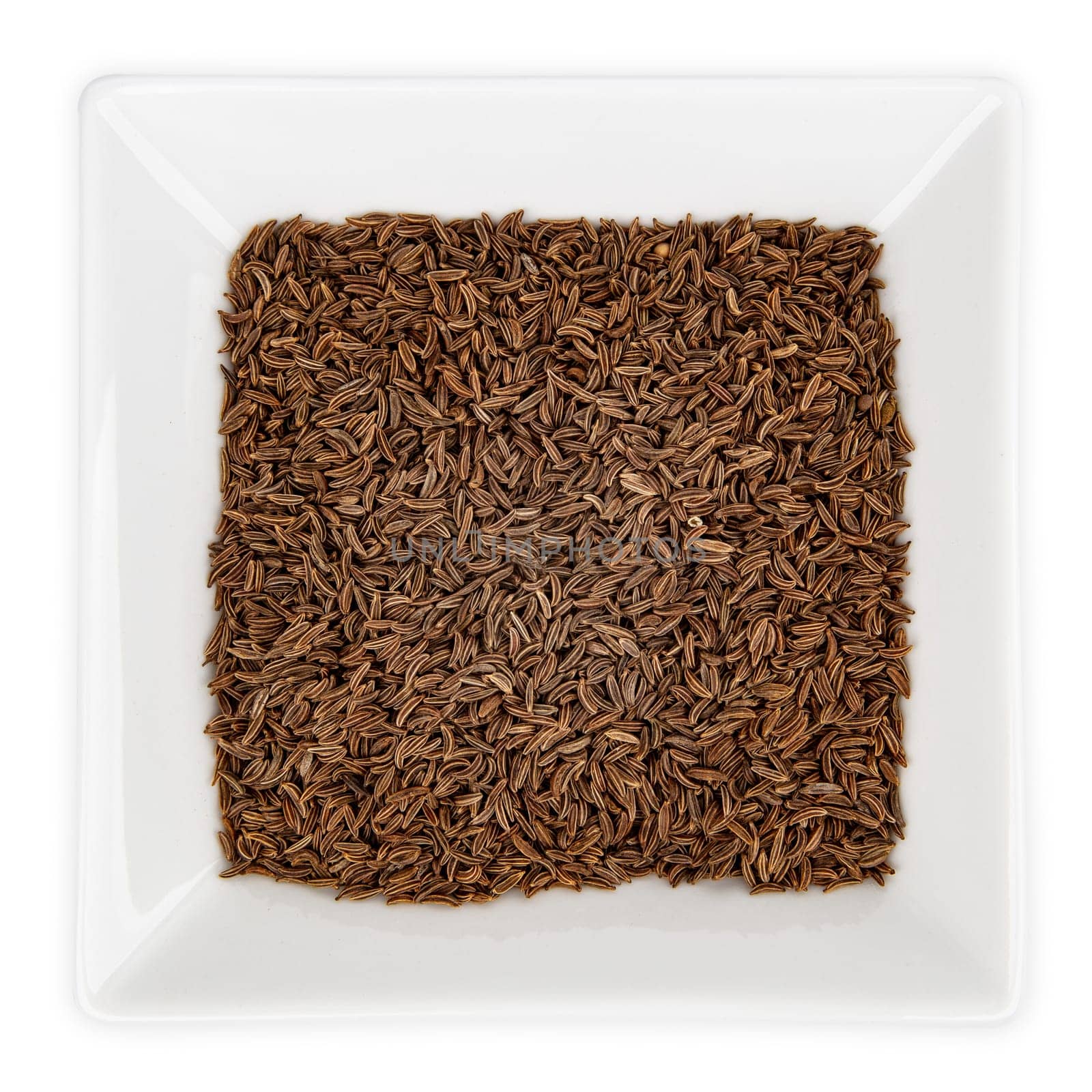 Caraway seeds in a bowl isolated on white background