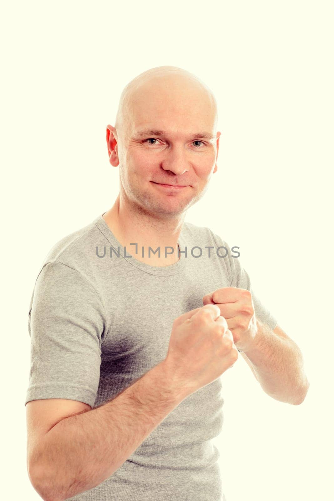 funny young man with fist- hands grining in to the camera