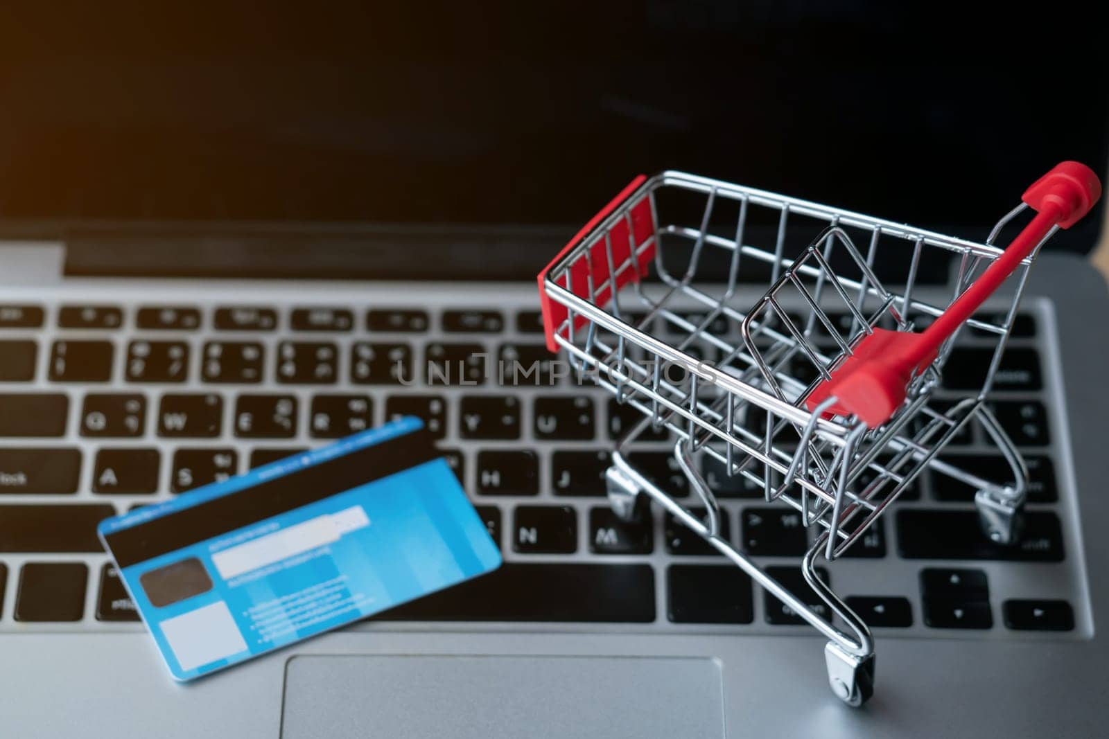 shopping cart and cradit card on laptop, online shopping concept