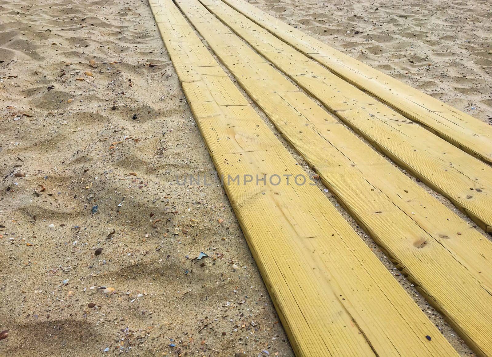 Wooden planks walking path in a beach landscape close up background texture