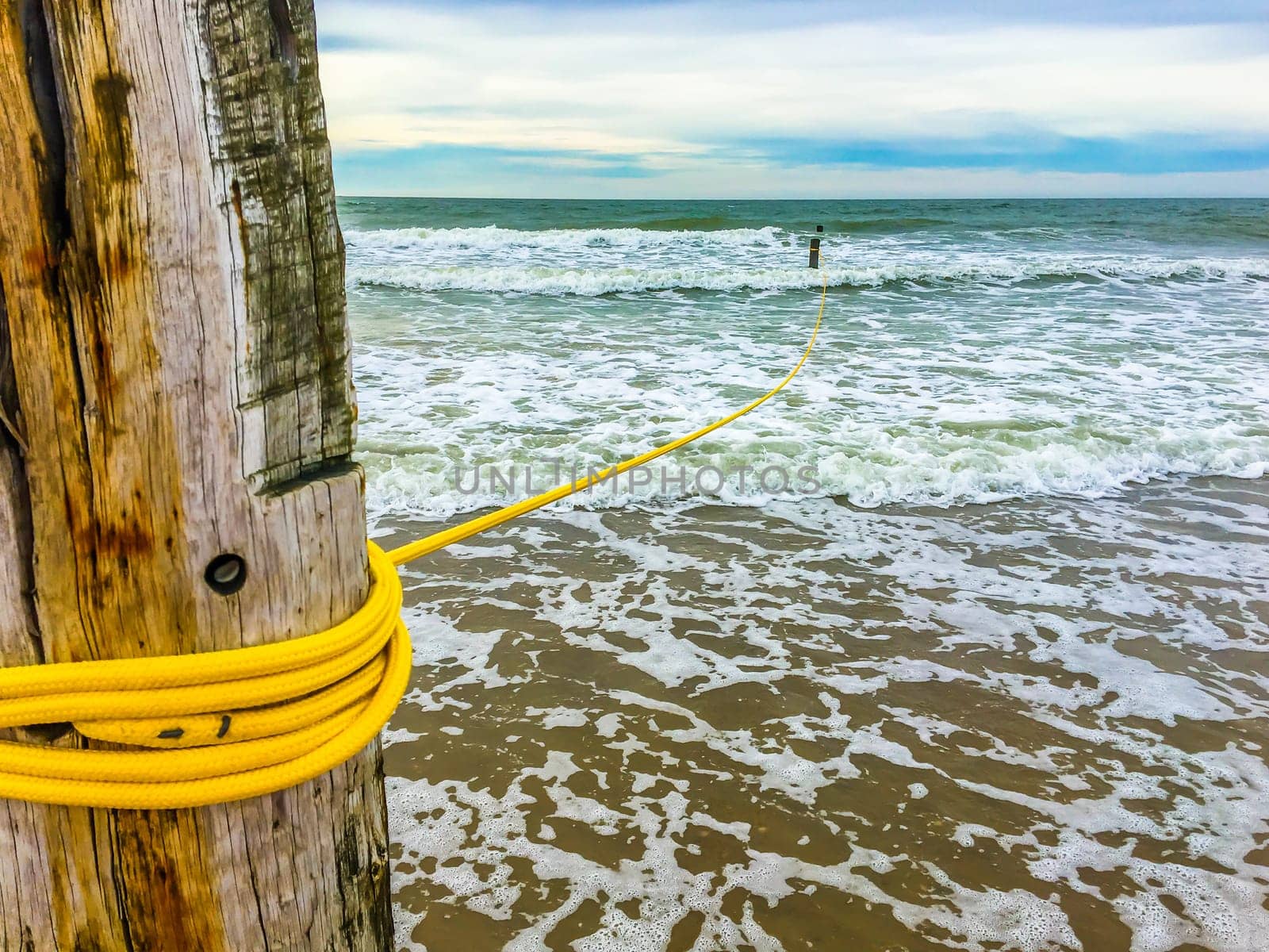 Rope line on a wooden pole in the ocean wild sea landscape