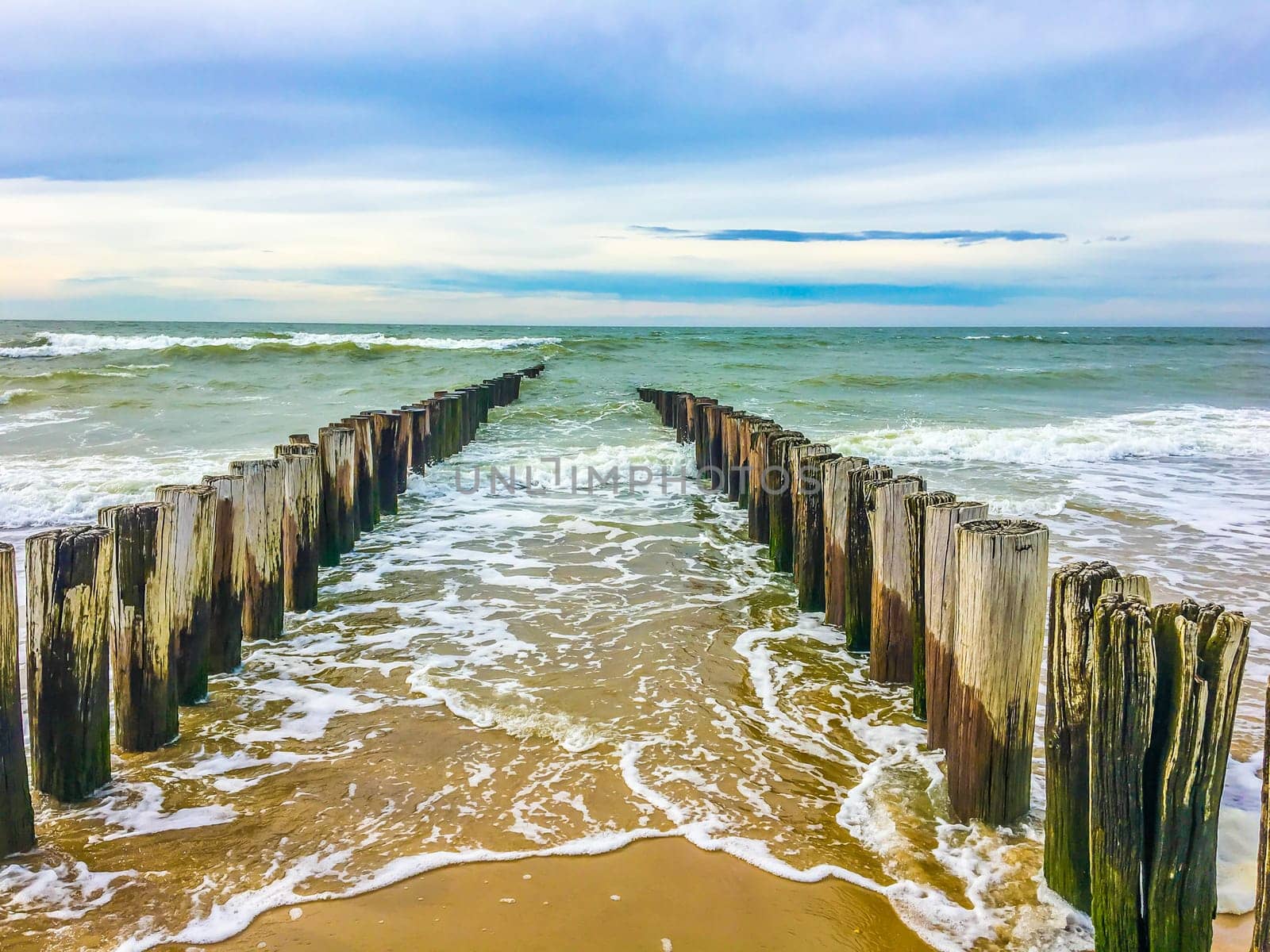 Beautiful beach landscape with ocean coastline and poles