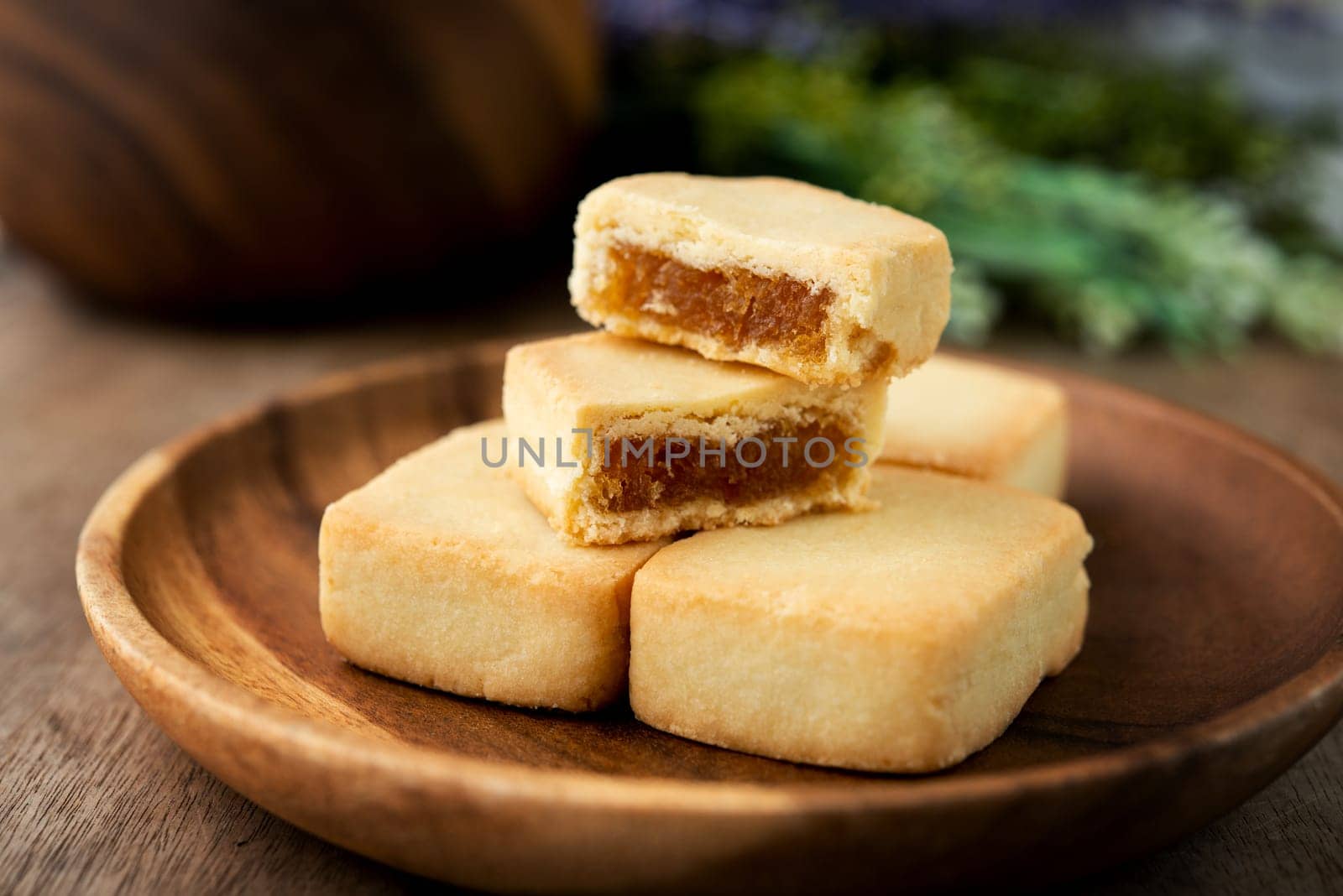 Pineapple cake is a sweet traditional Taiwanese pastry containing butter, flour, egg, sugar, and pineapple jam.