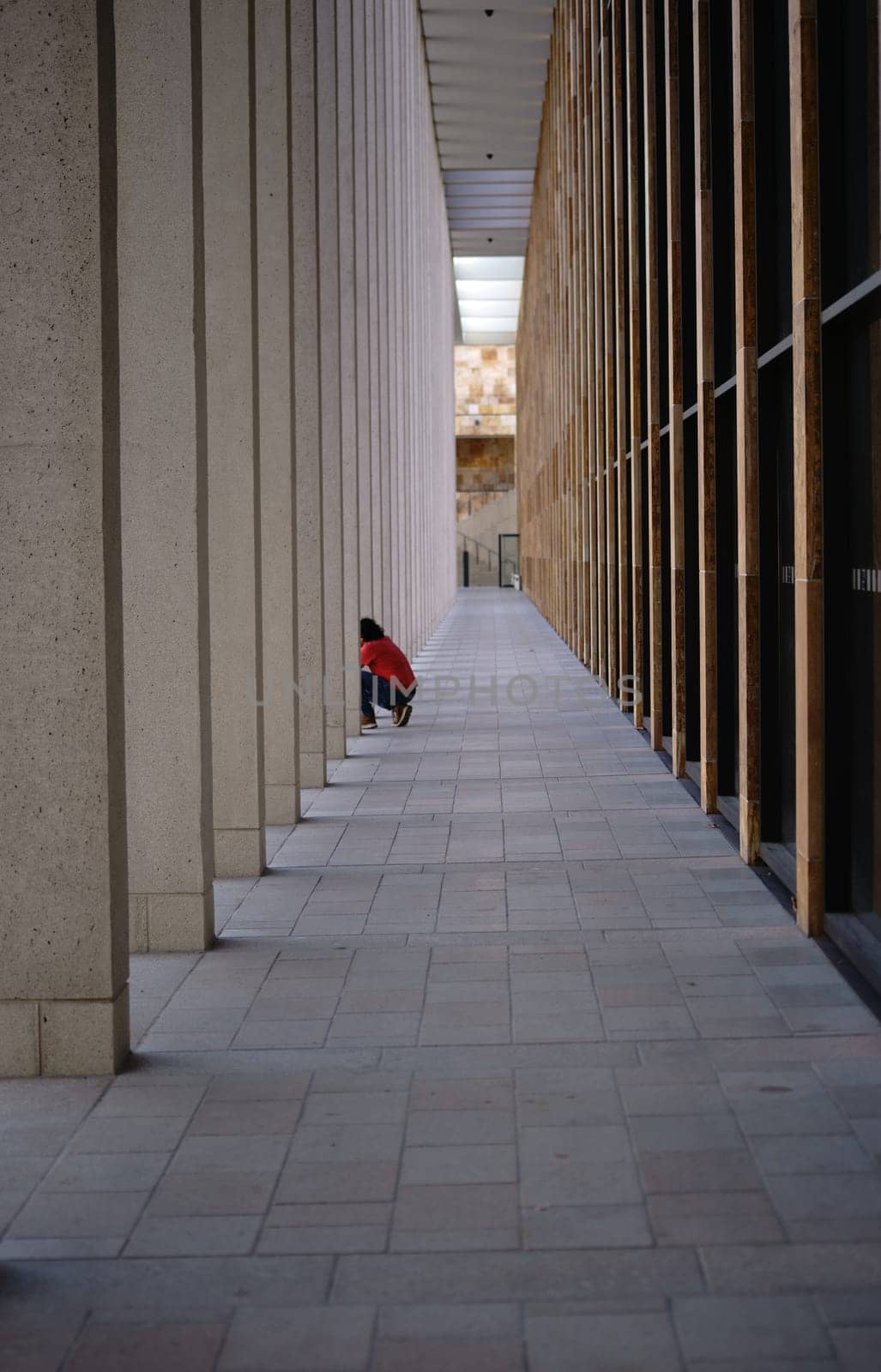A Tourist photographes between the modern square pillars of the Rhein Main Congress Center..