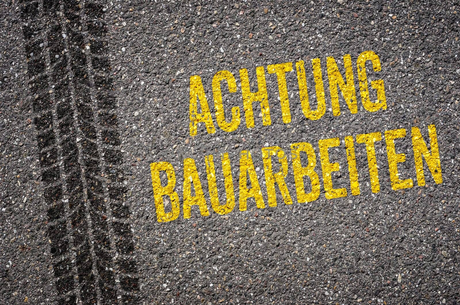 Lane with the German Translation of Caution Road work - Achtung Bauarbeiten
