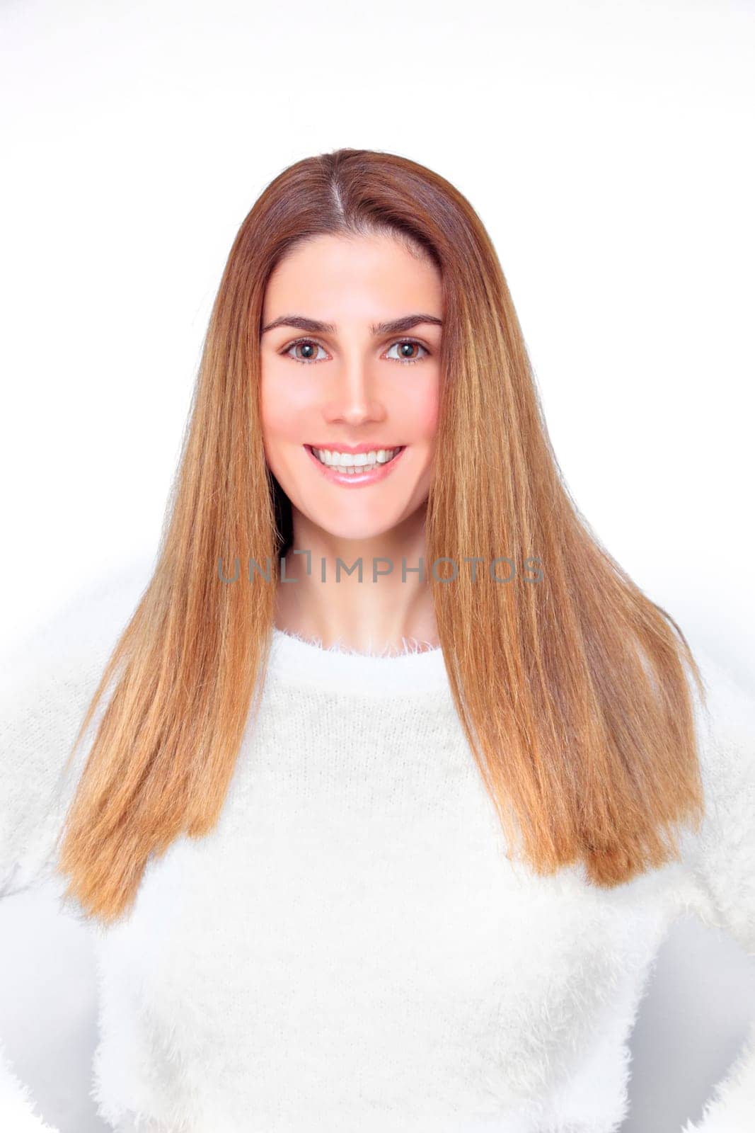 Laughing blond woman winks and holds up her hair