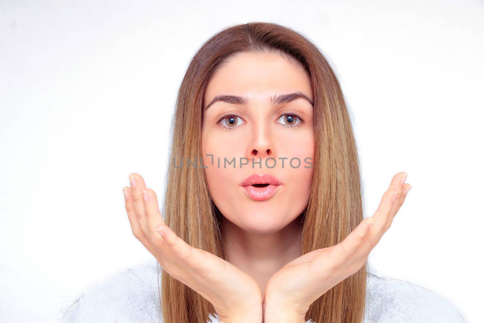 Beautiful woman with closed eyes meditates with her hands in front of her face