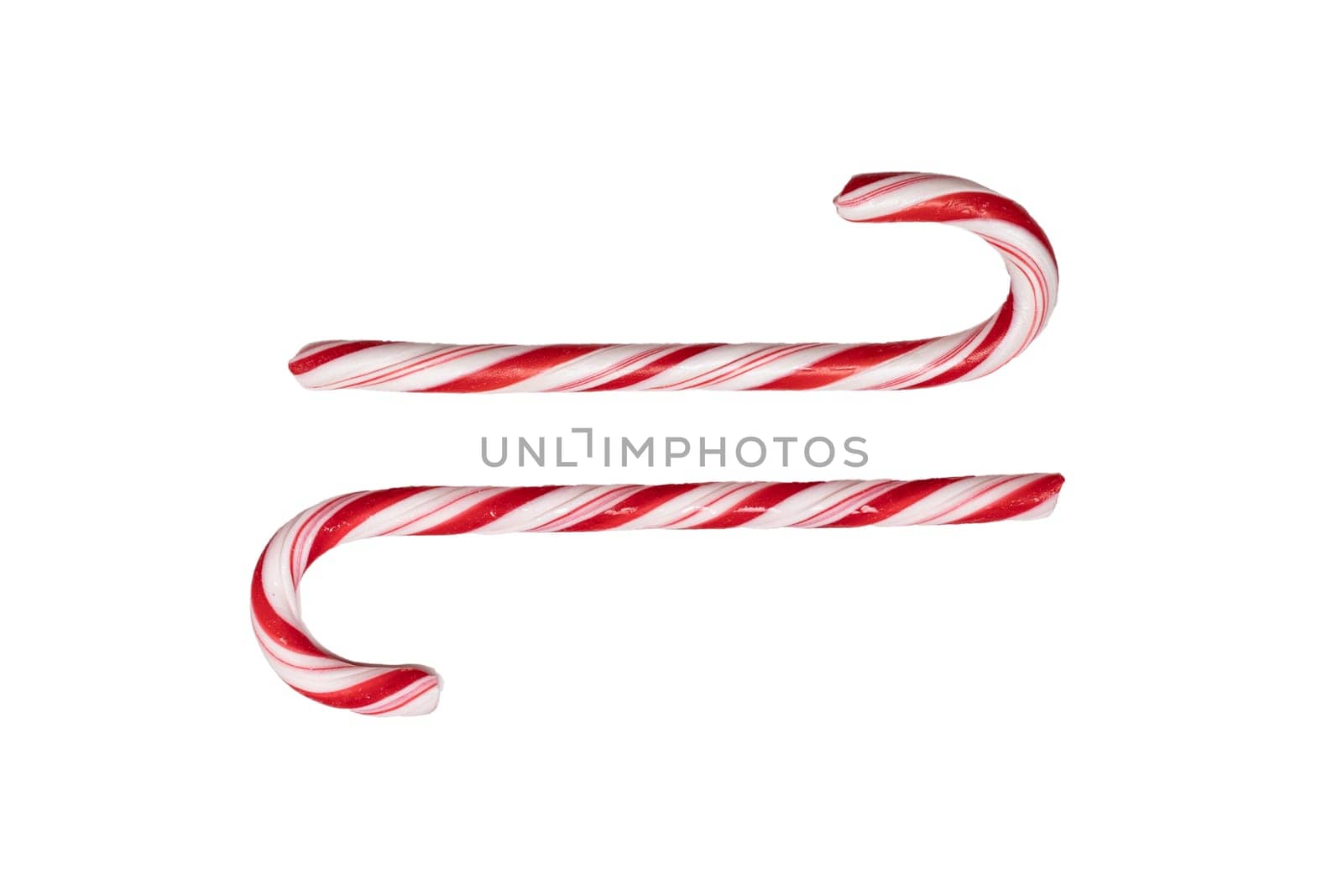 Traditional Christmas striped candy cane isolated on a white background. Top view.