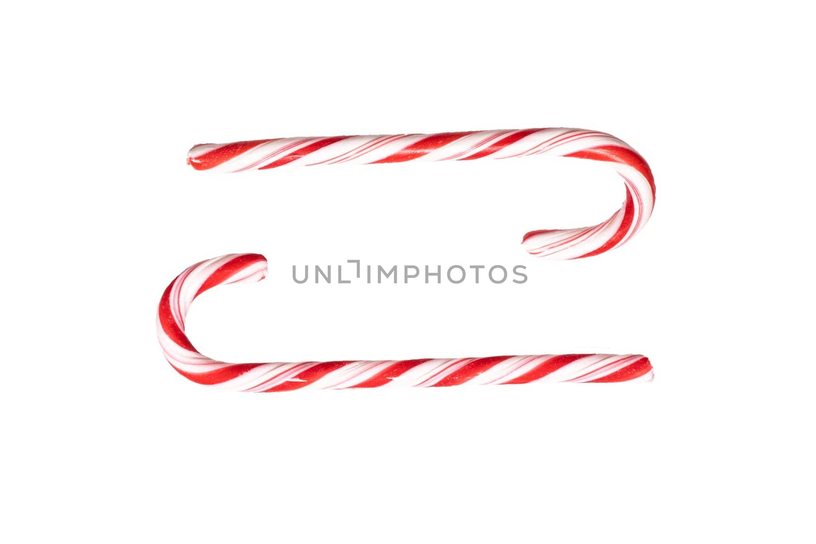 Traditional Christmas striped candy cane isolated on a white background. Top view.