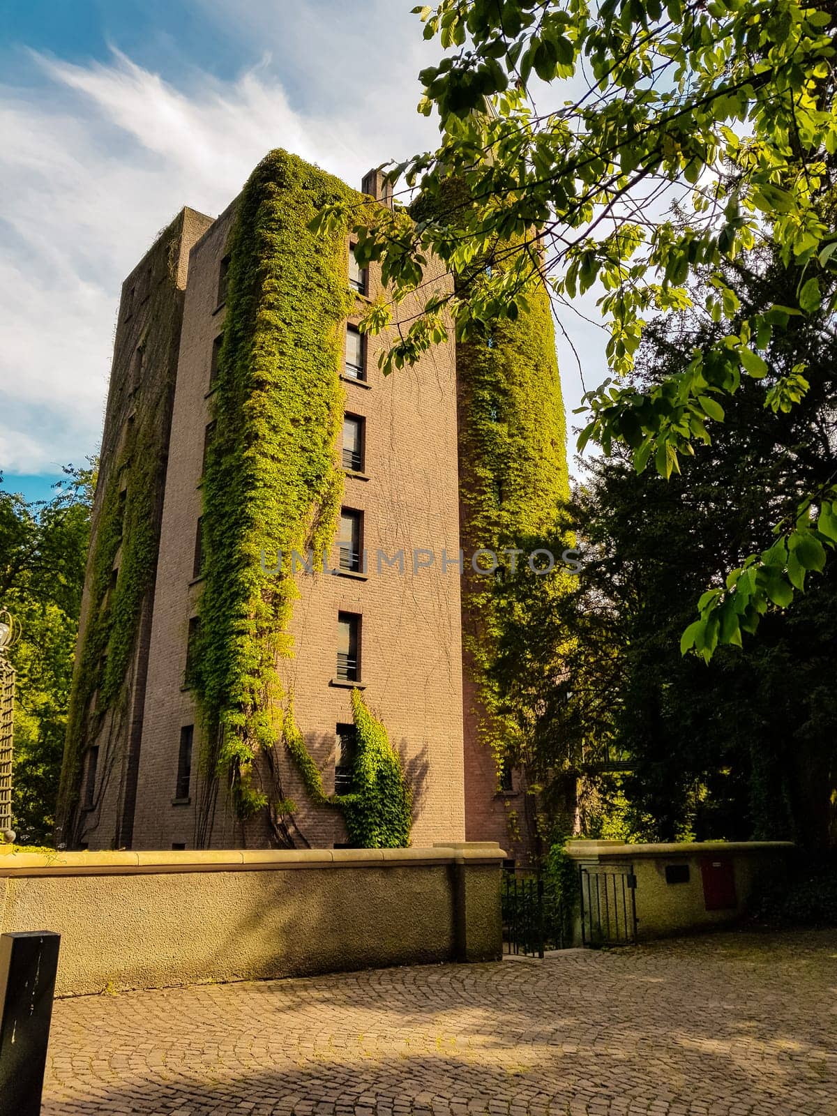 Flat high brick house block with tower