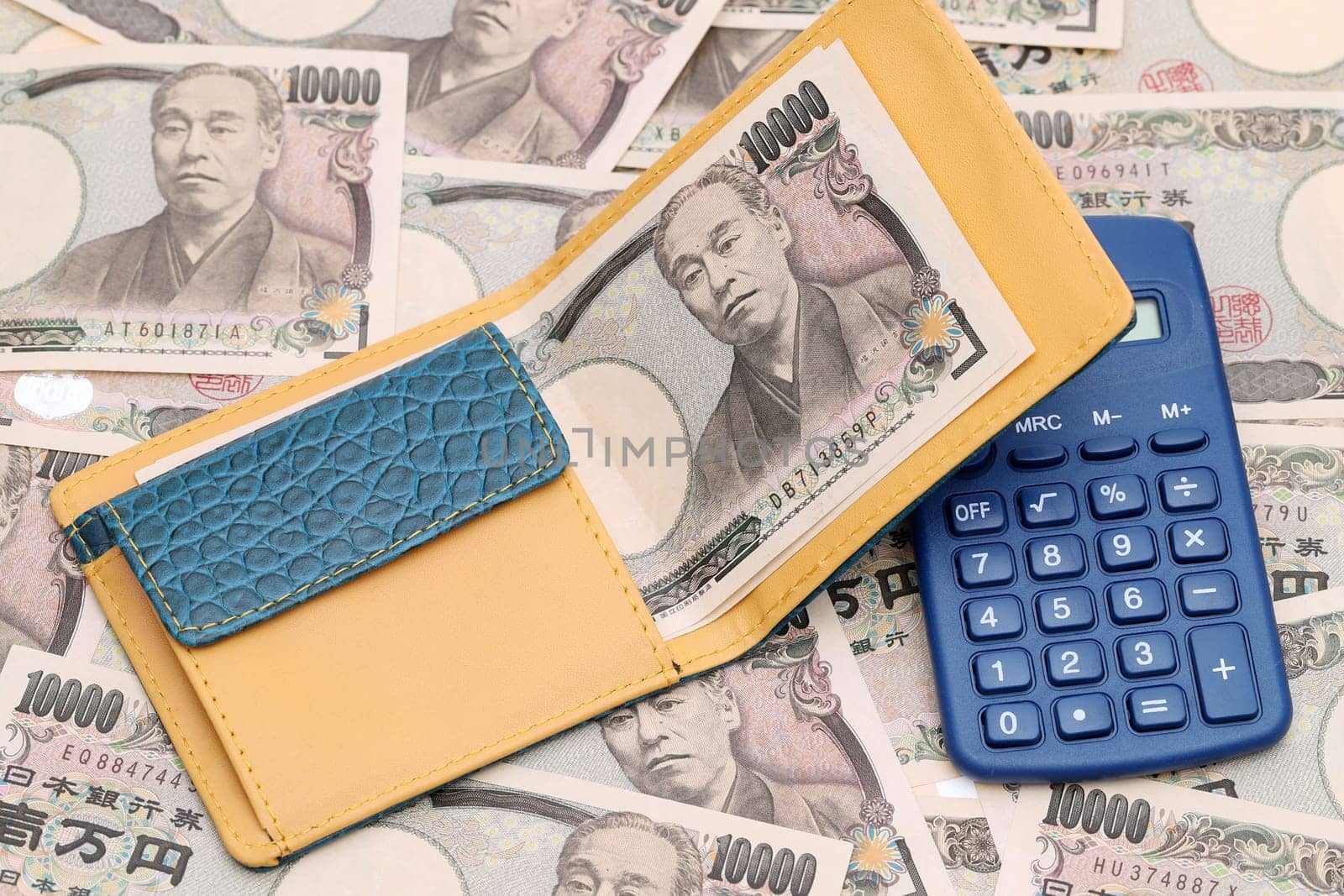 Leather wallet with ten thousand yen on japanese bill background
