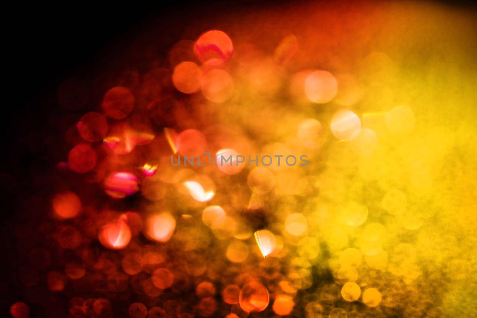 Red yellow glitter lights bokeh background defocused.