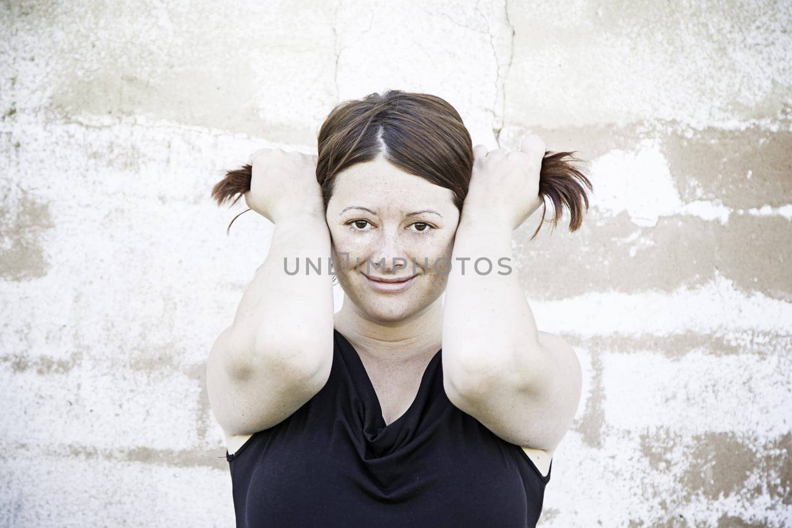 Happy girl with pigtails and urban street people