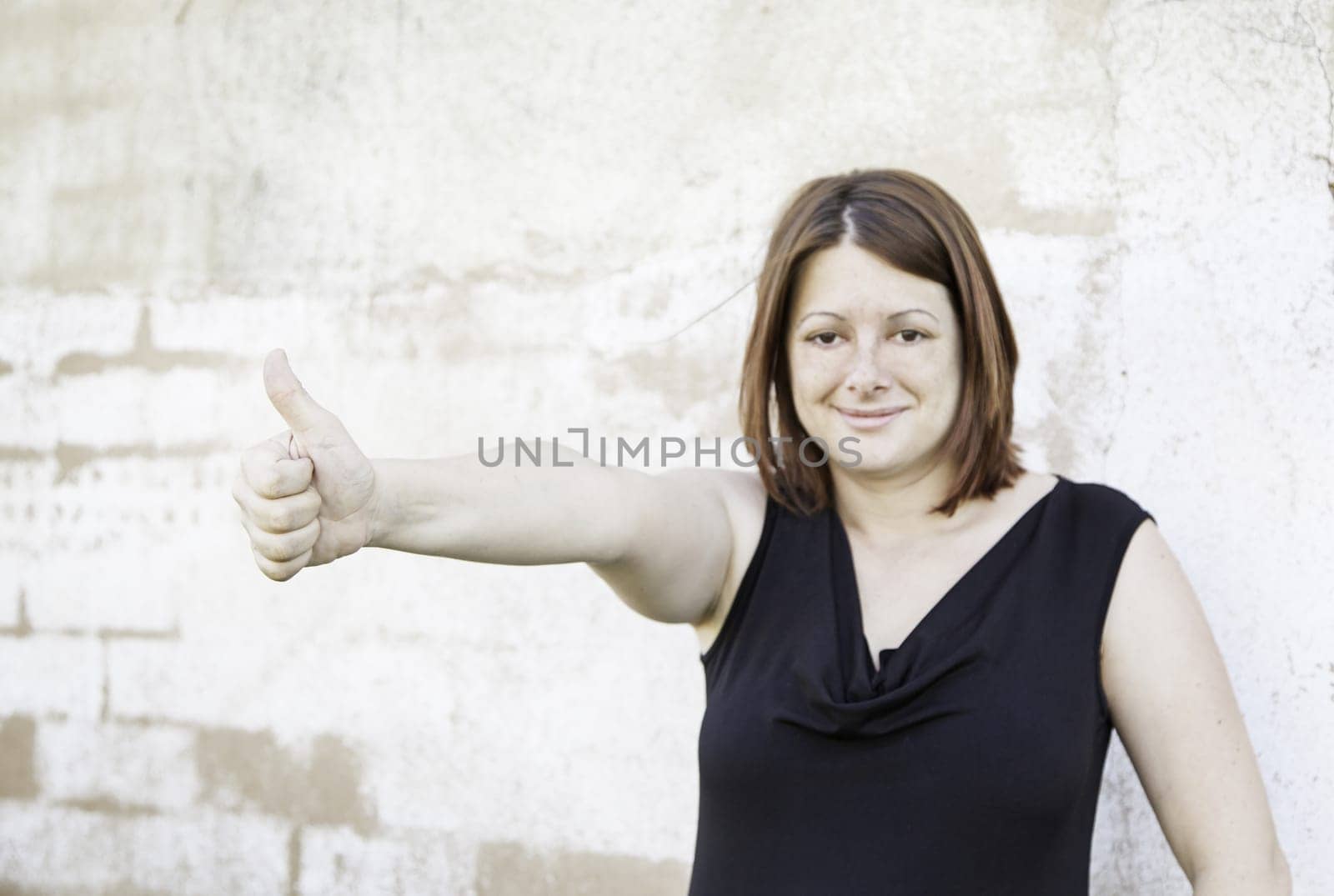 Optimistic and winning girl on city street