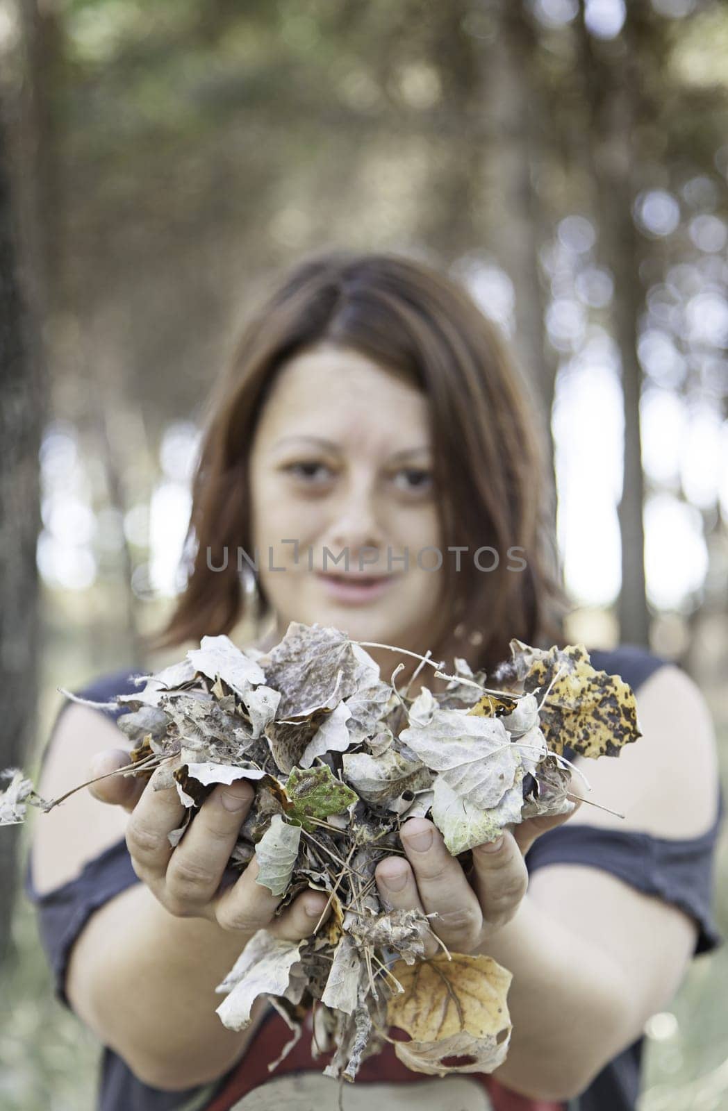 Woman autumn leaves in park with trees, nature