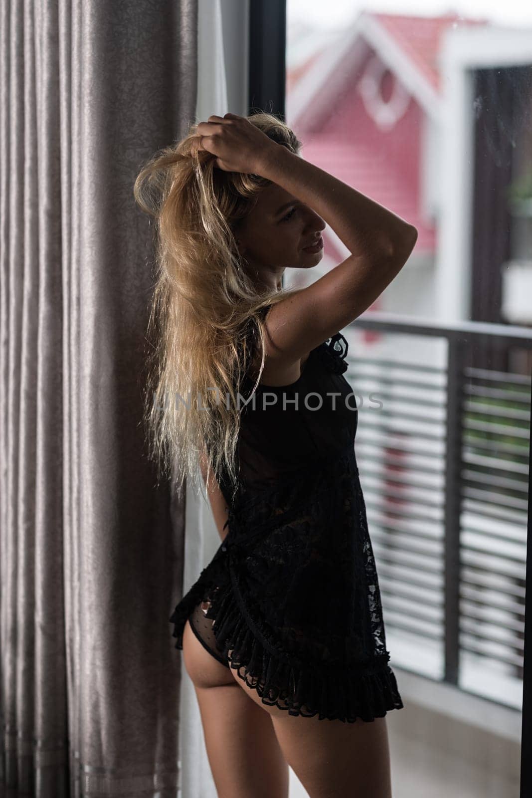 Beautiful woman posing at the window
