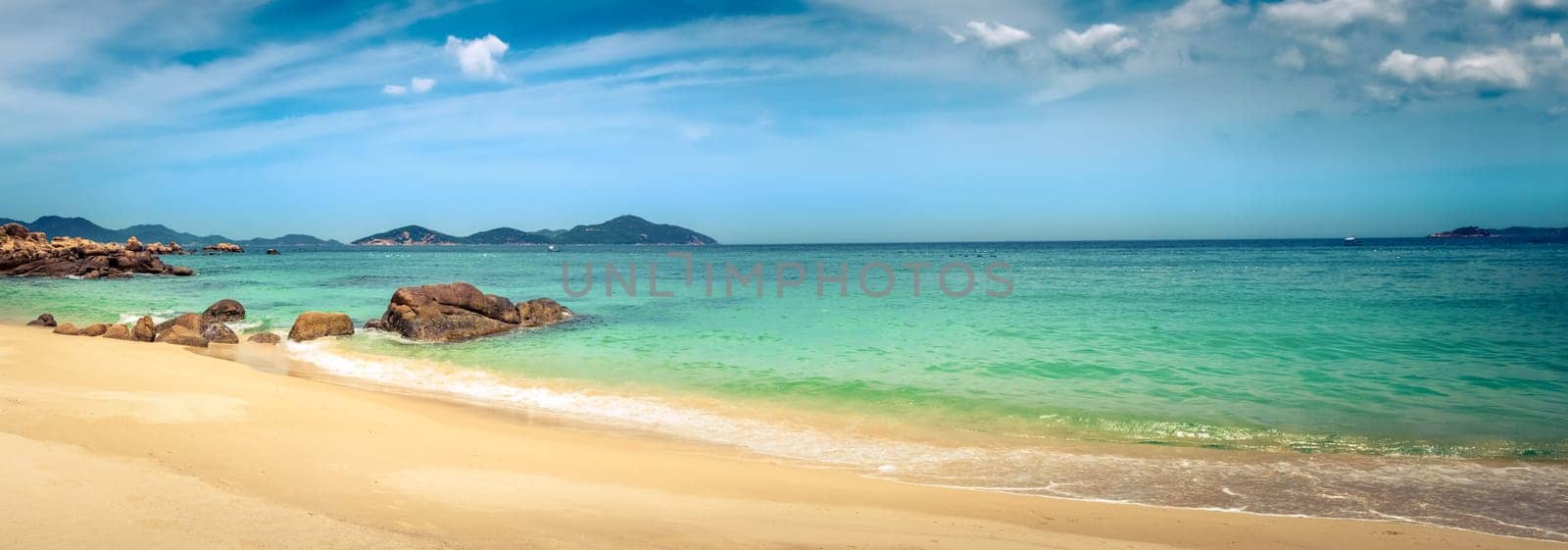 Beautiful white sand beach. Stones on a foreground. Landscape of Vietnam. Panorama
