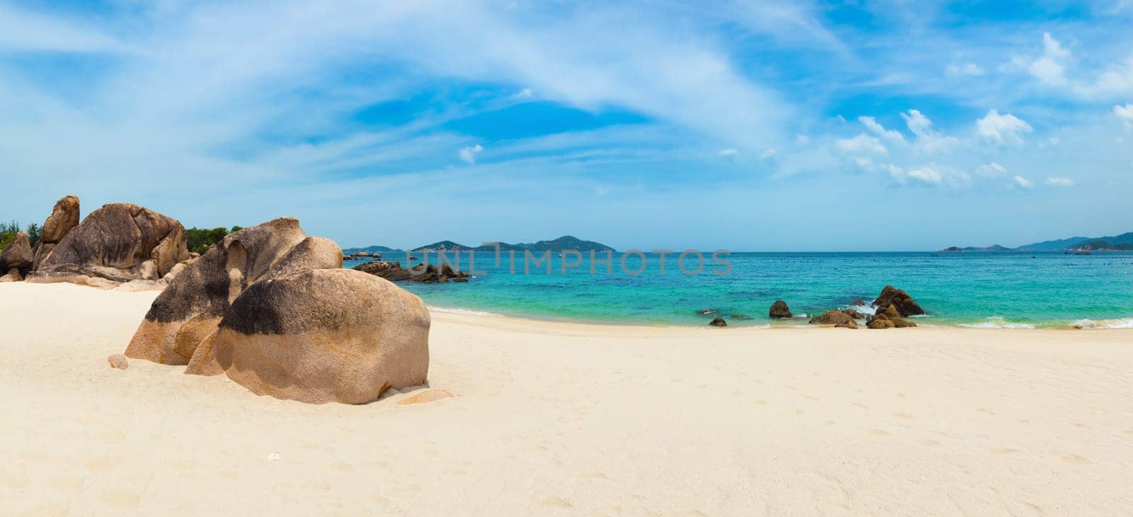 Beautiful white sand beach. Stones on a foreground. Landscape of Vietnam. Panorama