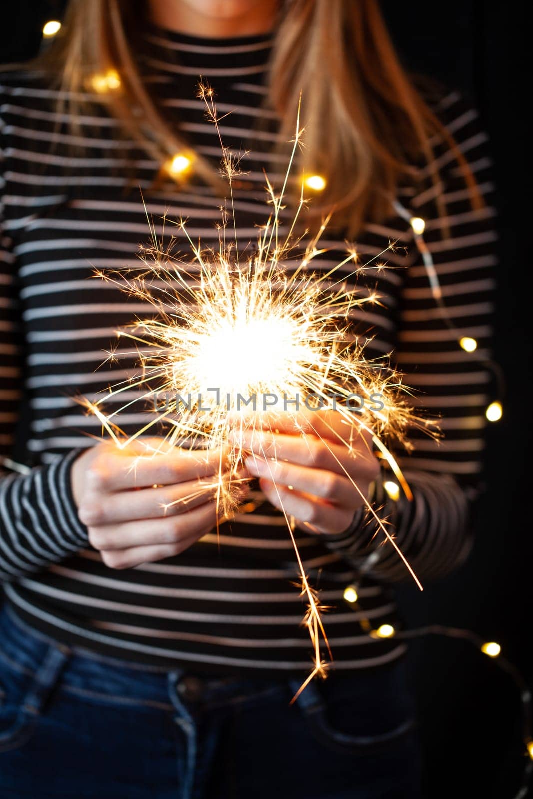 Girl hands holding burning sparklers