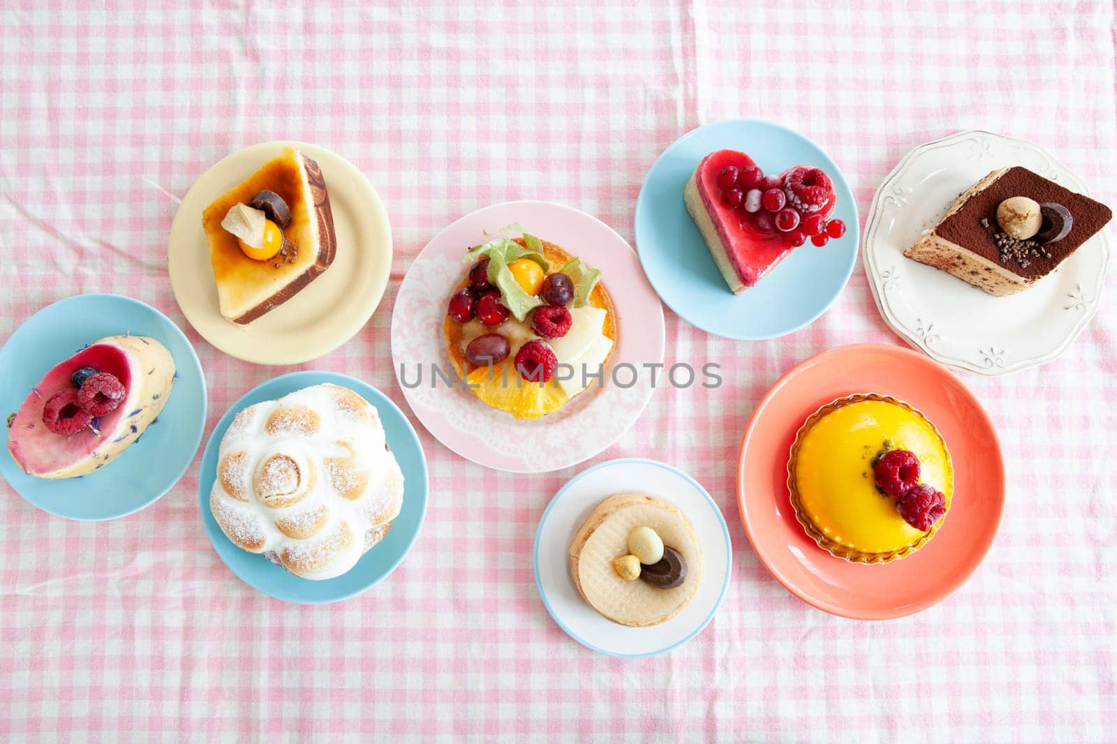 Delicious little cakes and pies on colorful plates
