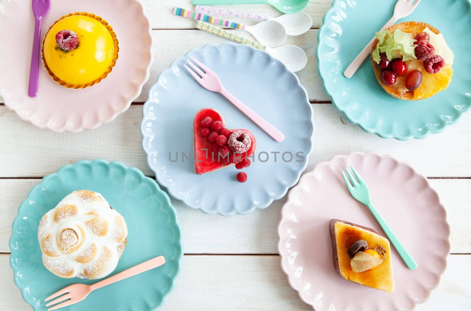 Delicious little cakes and pies on colorful plates