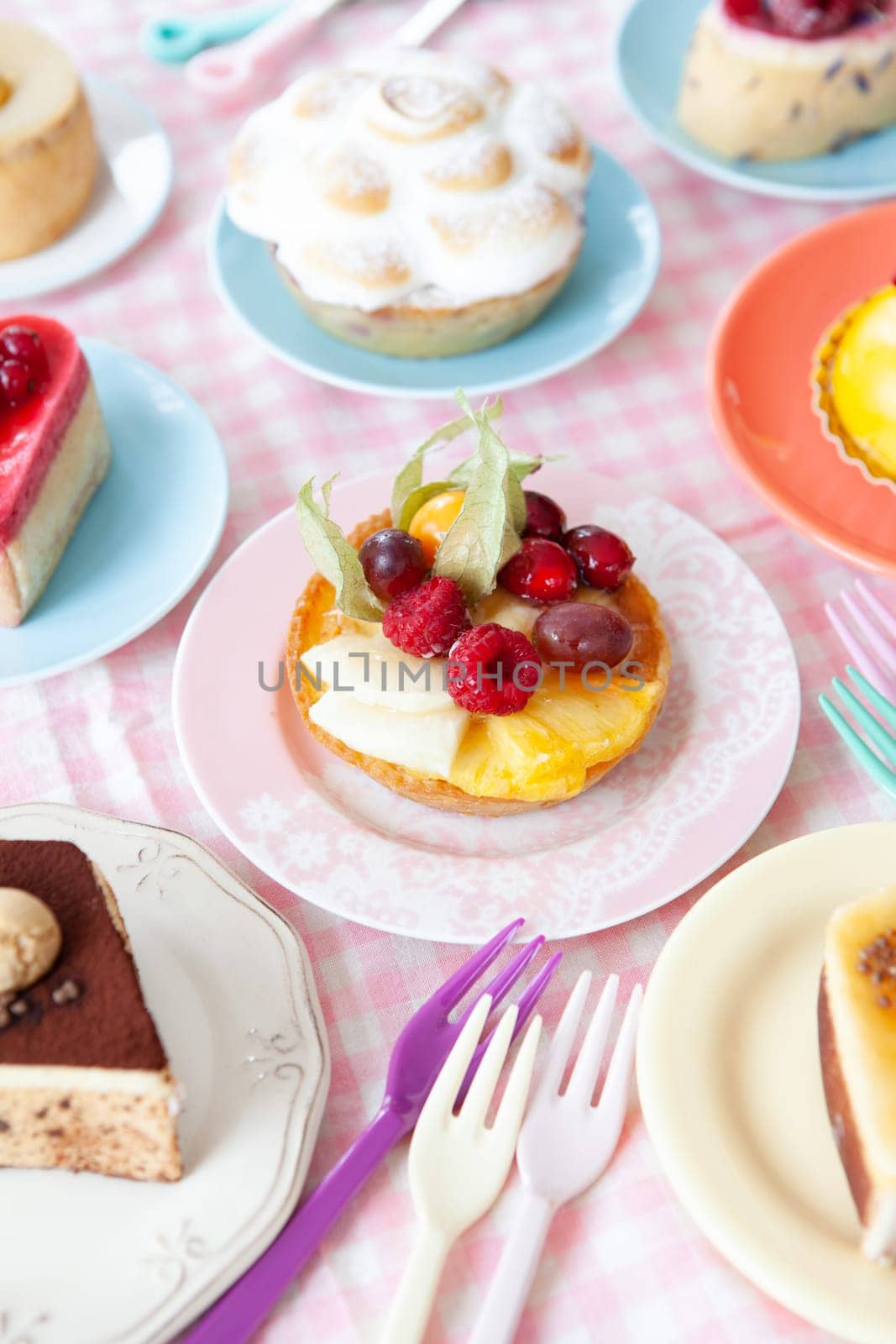 Delicious little cakes and pies on colorful plates