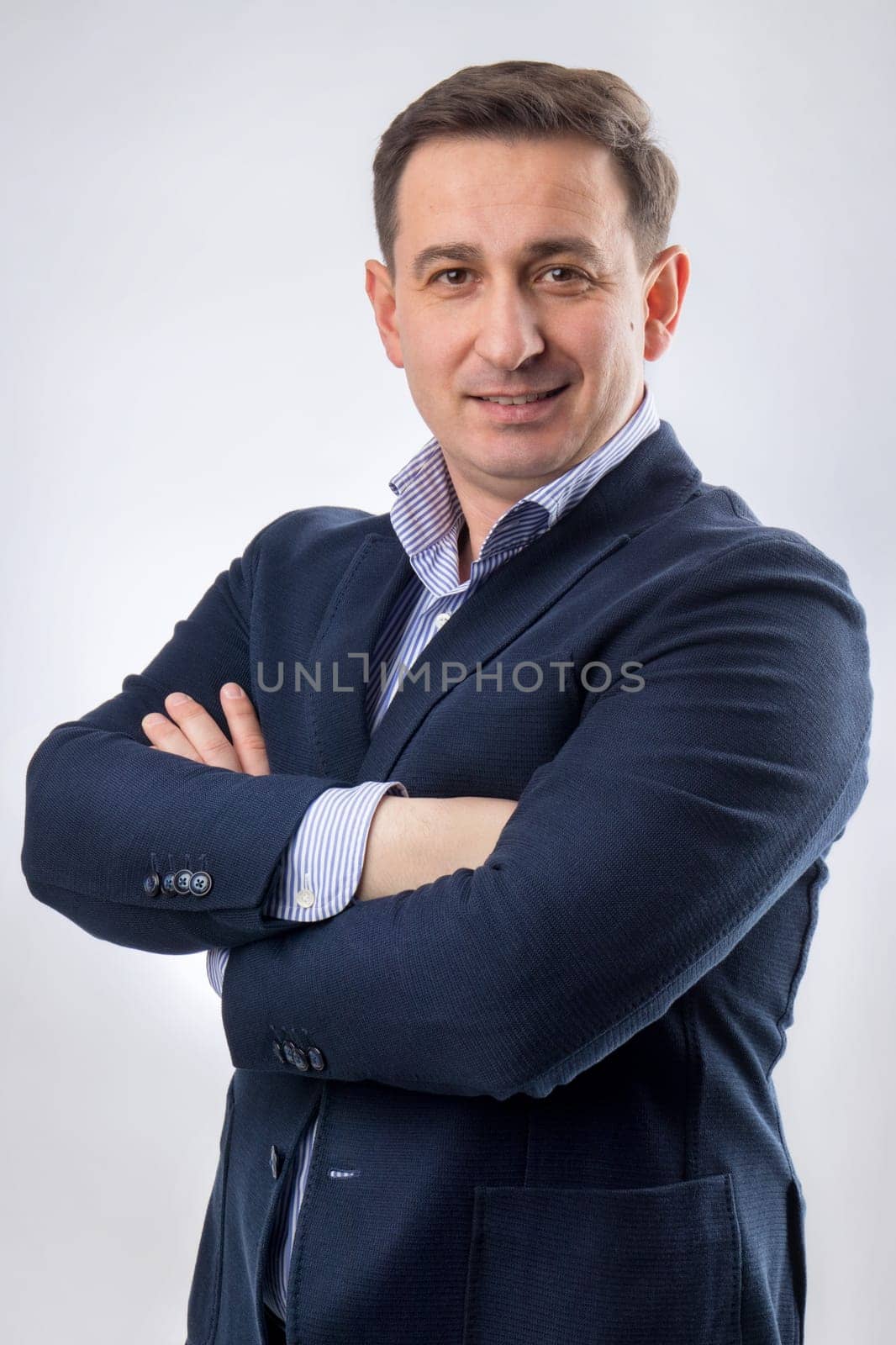 Portrait of a handsome young middle aged CEO in a blue suit and smiling