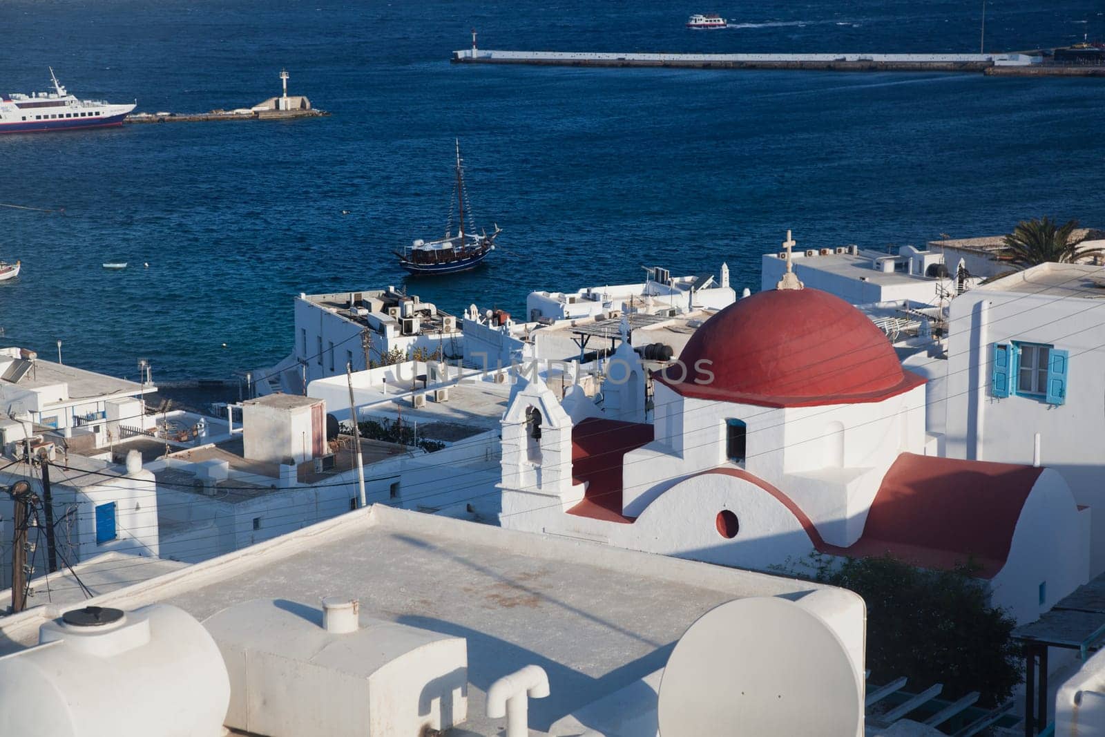 panoramic view of the Mykonos town harbor from the above hills on a sunny summer day, Mykonos, Cyclades, Greece