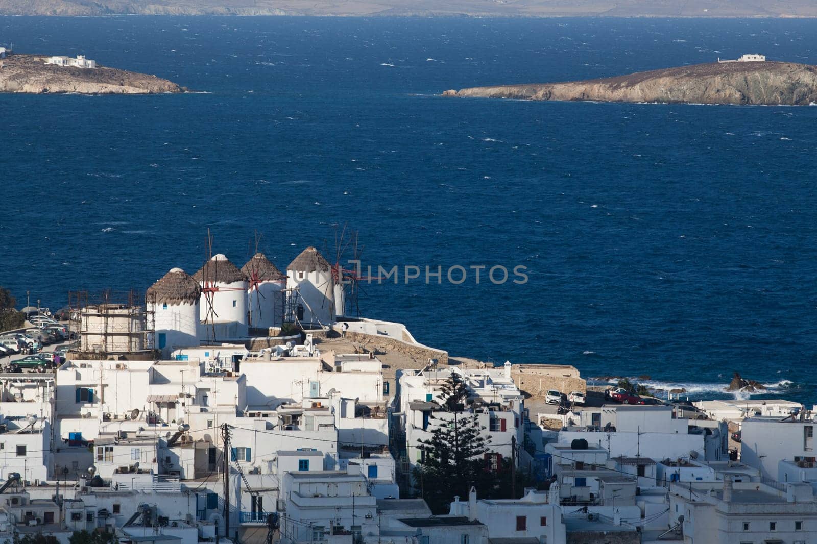 panoramic view of the Mykonos town harbor from the above hills on a sunny summer day, Mykonos, Cyclades, Greece