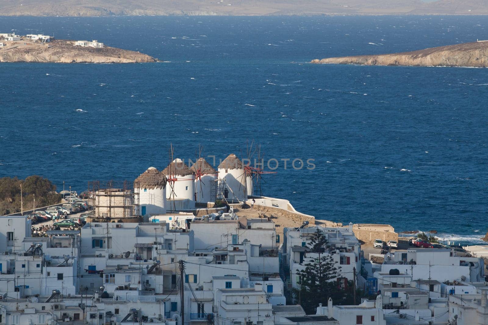 panoramic view of the Mykonos town harbor from the above hills on a sunny summer day, Mykonos, Cyclades, Greece