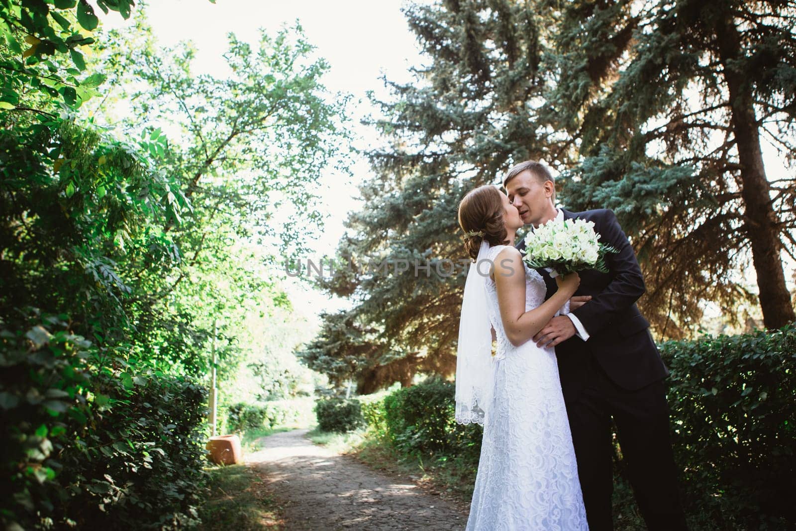 couple bride and groom on a park background.
