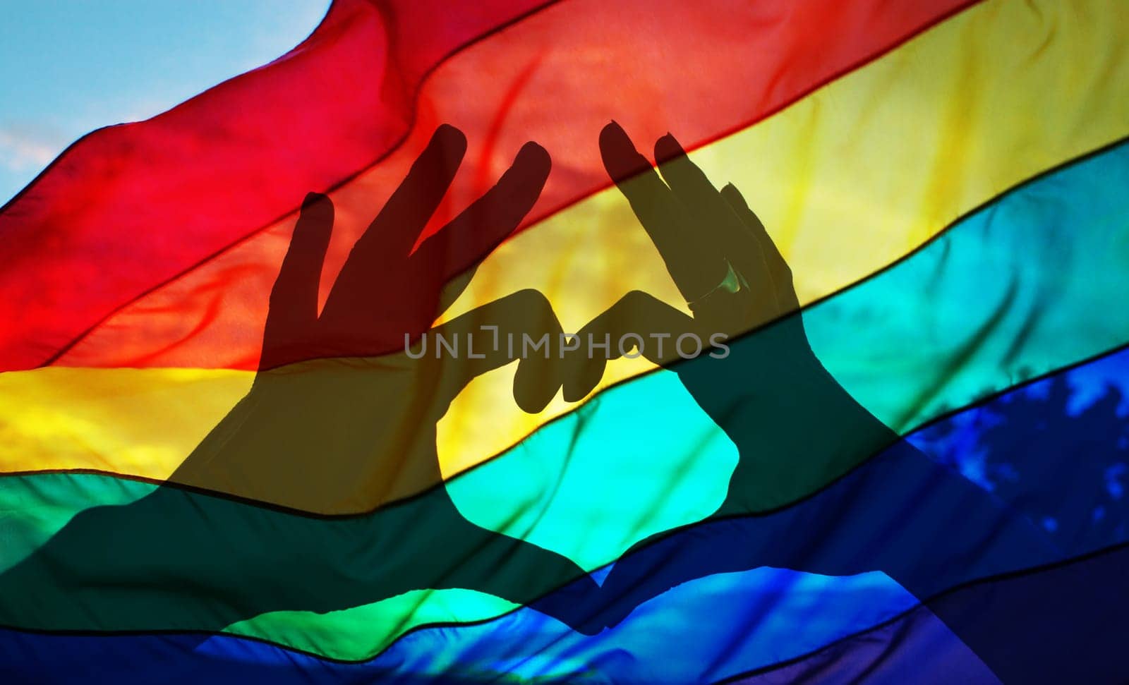 beautiful colorful sunset background - heart shape hands