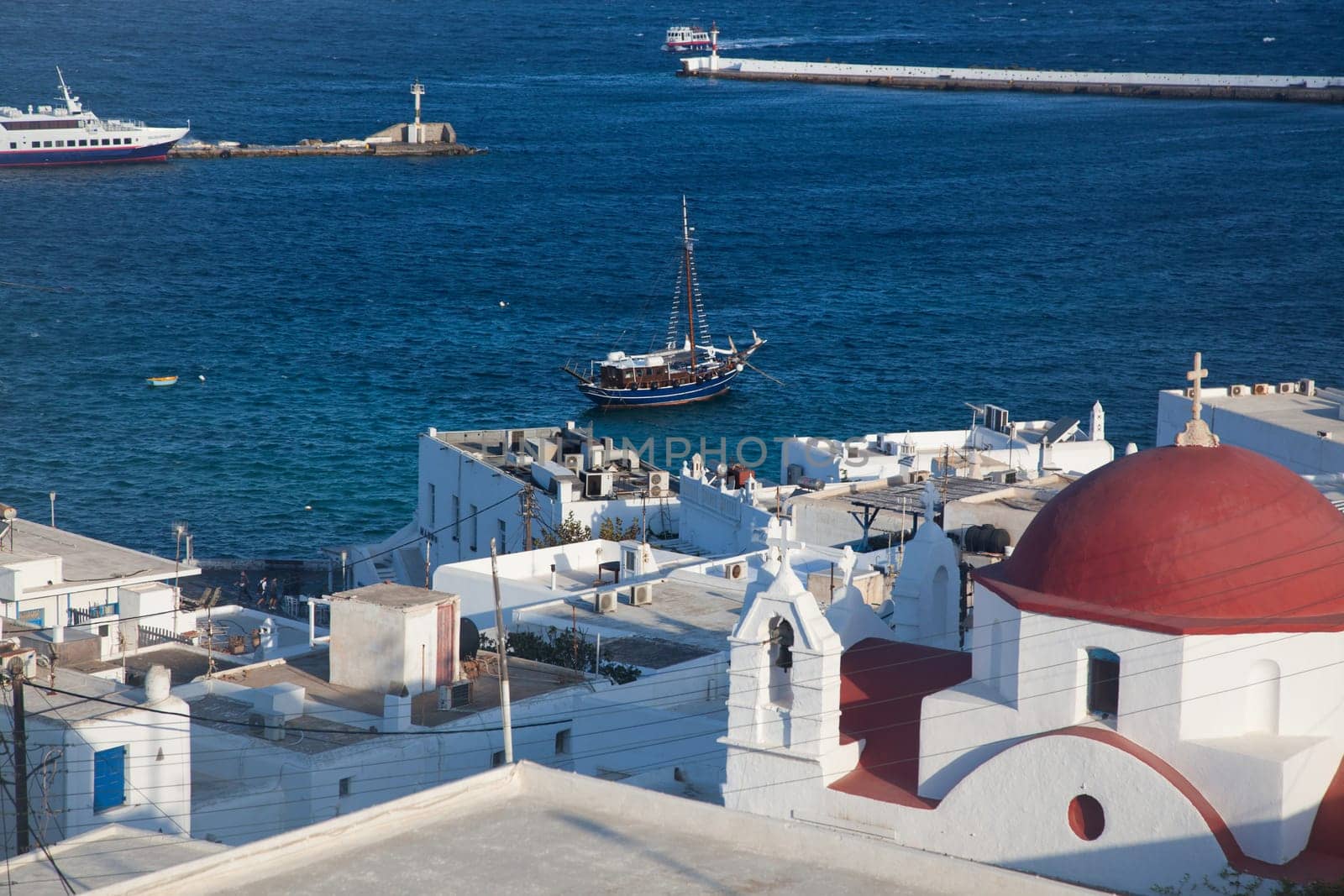panoramic view of the Mykonos town harbor from the above hills on a sunny summer day, Mykonos, Cyclades, Greece