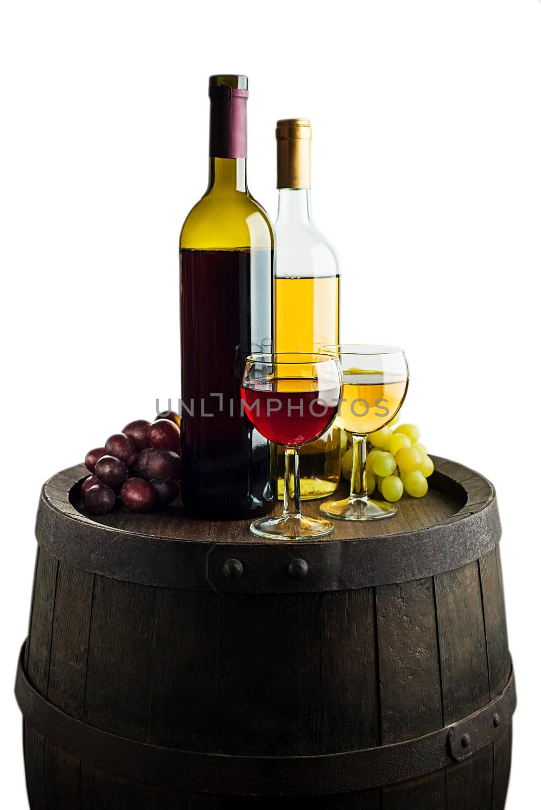 Glass and bottle of red wine and white wine on wooden barrel background