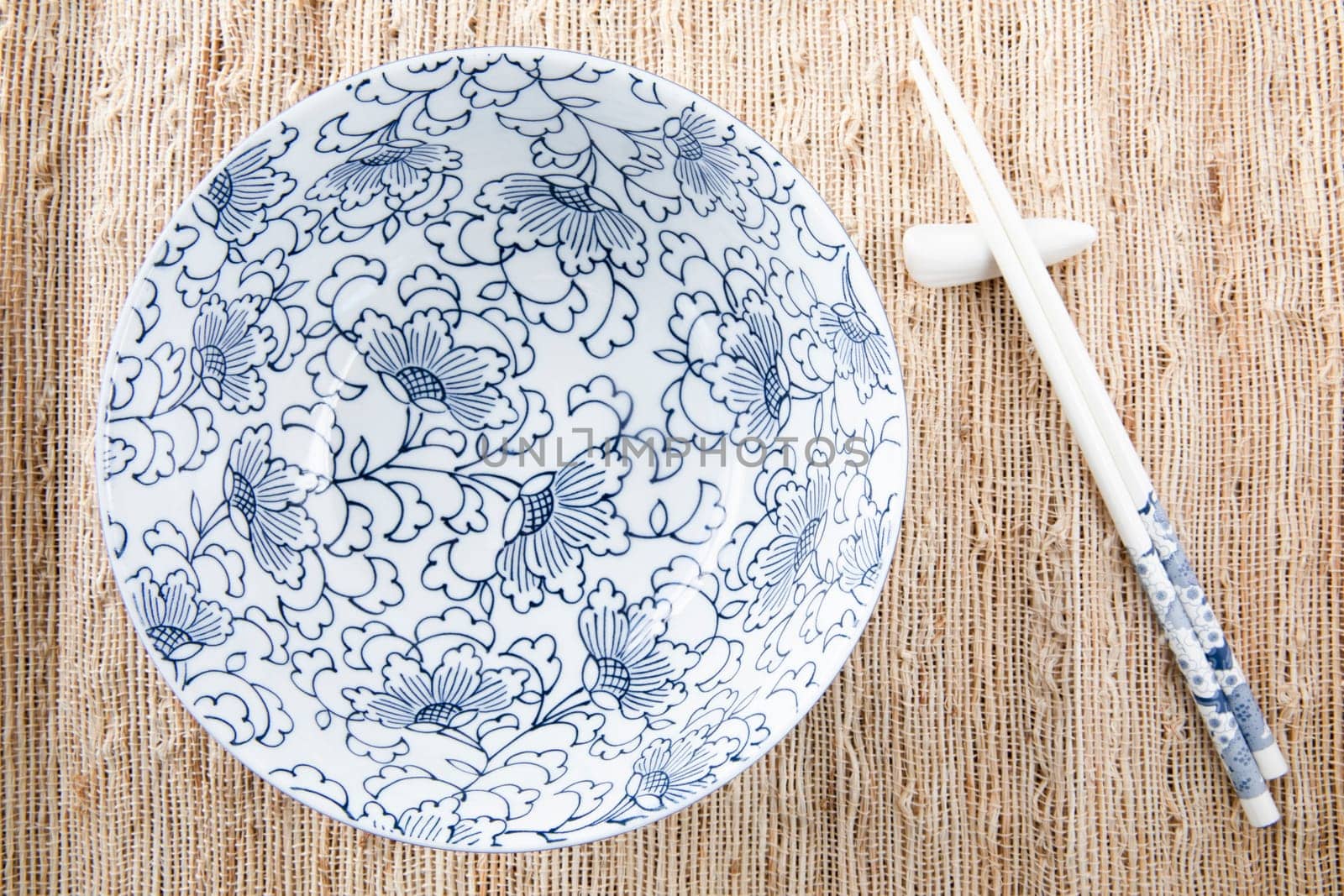 Filling bowl with udon noodle soup series image one, bowl and chopsticks.