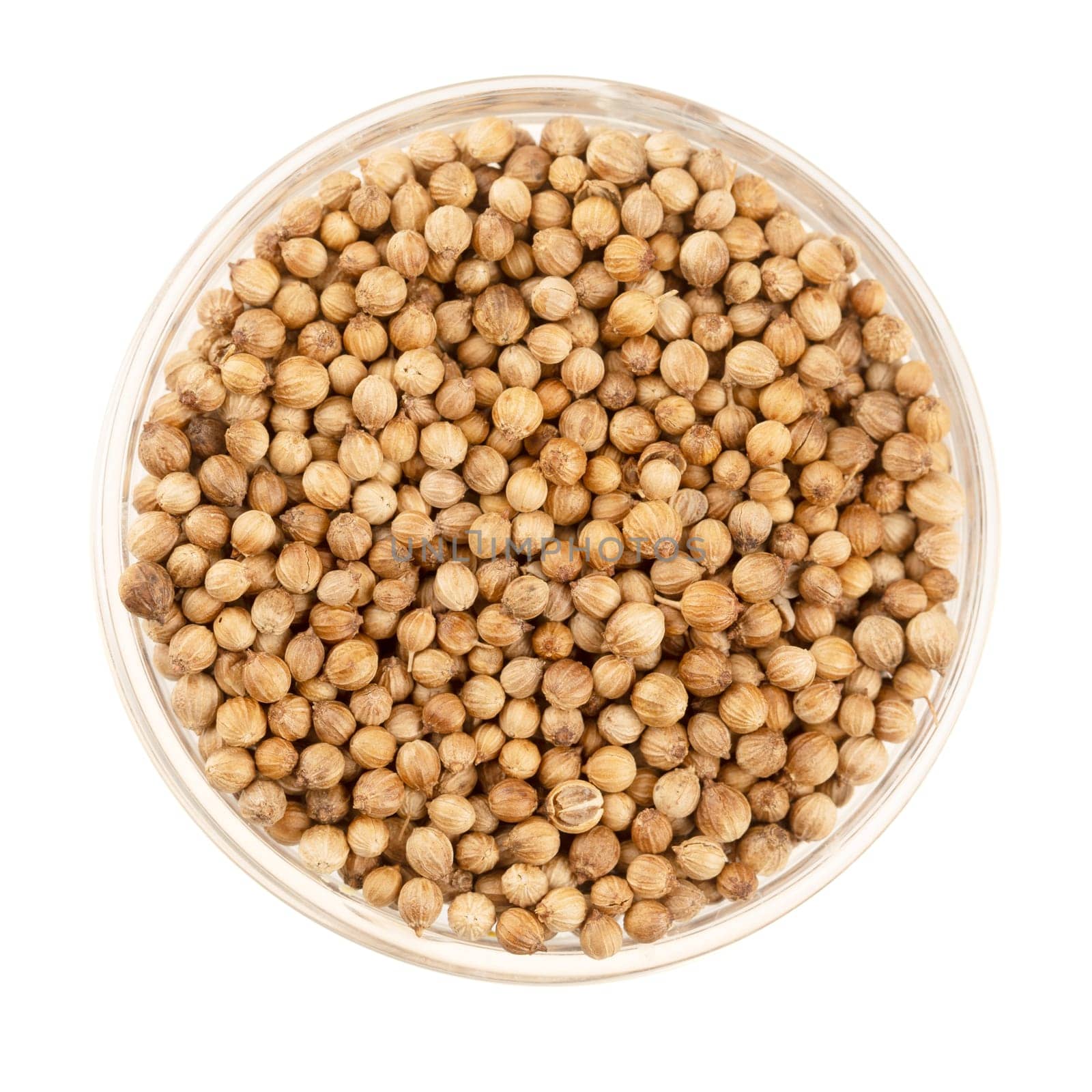 Glass bowl full of coriander seeds isolated on a white background viewed from direclty above.