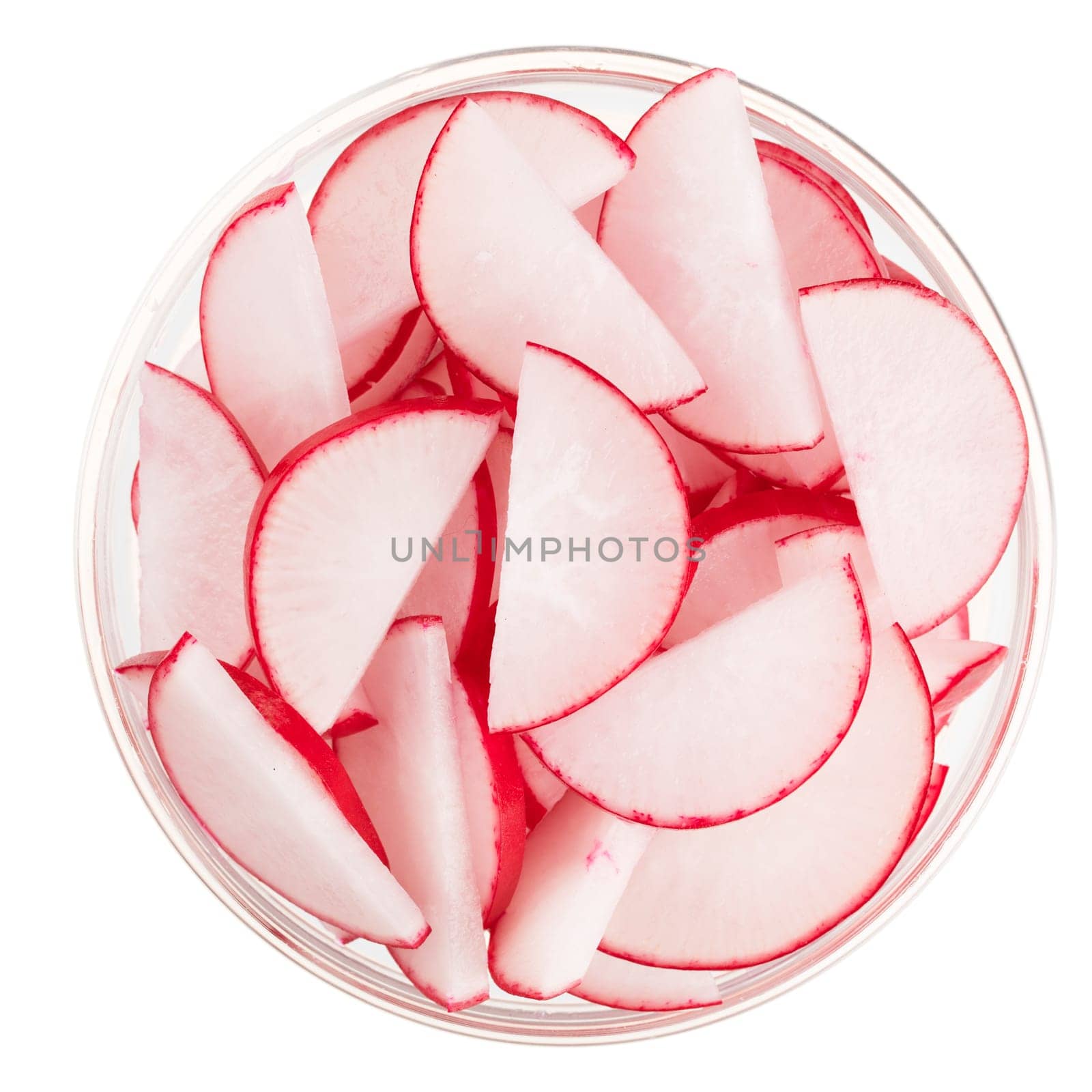 Radish slices in a glass bowl and isolated on a white background