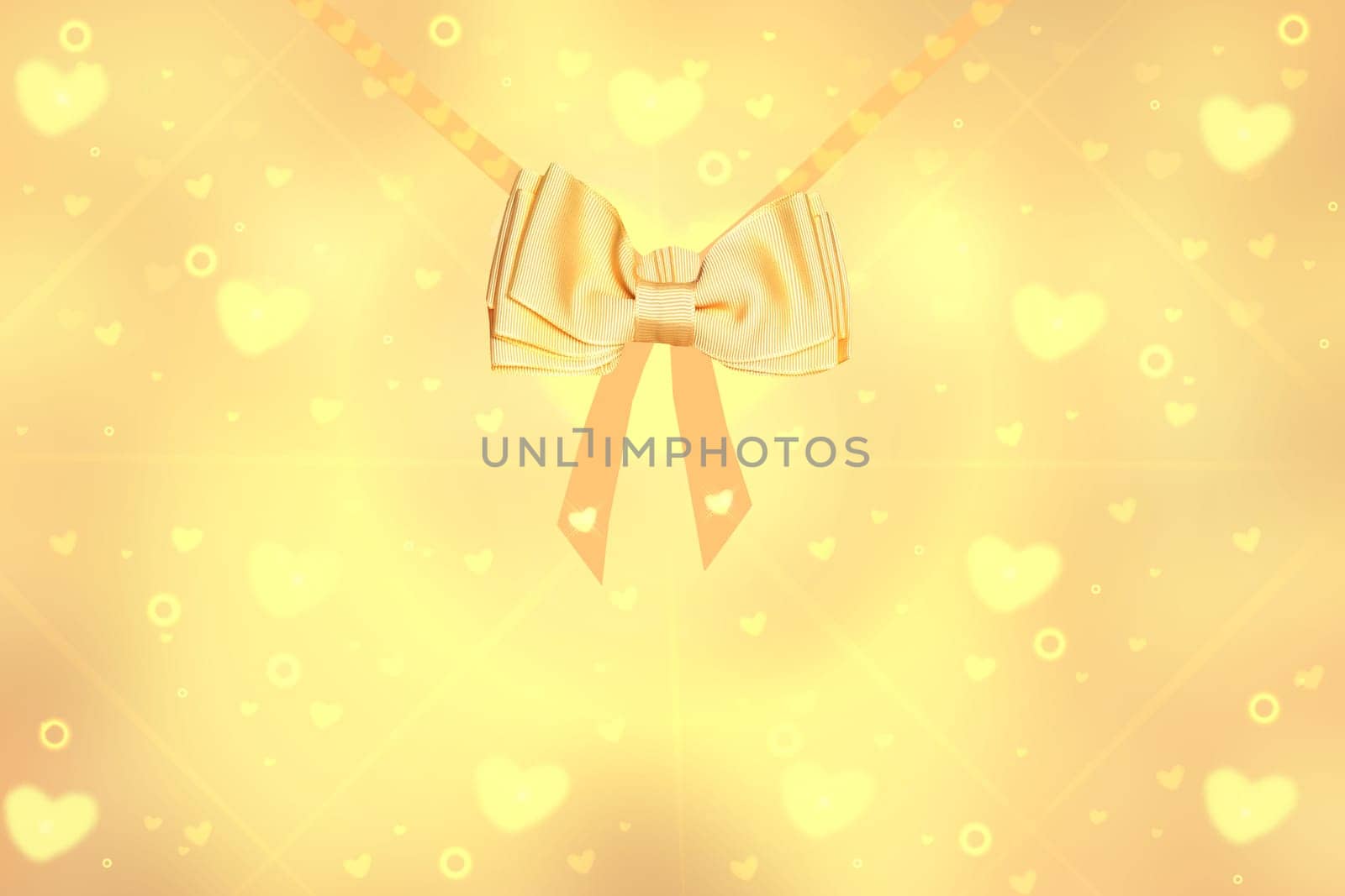 Festive backgrounds. Abstract festive blur bright golden background with golden ribbon bow for valentine or wedding. Romantic textured backdrop with space for your design. Card concept.