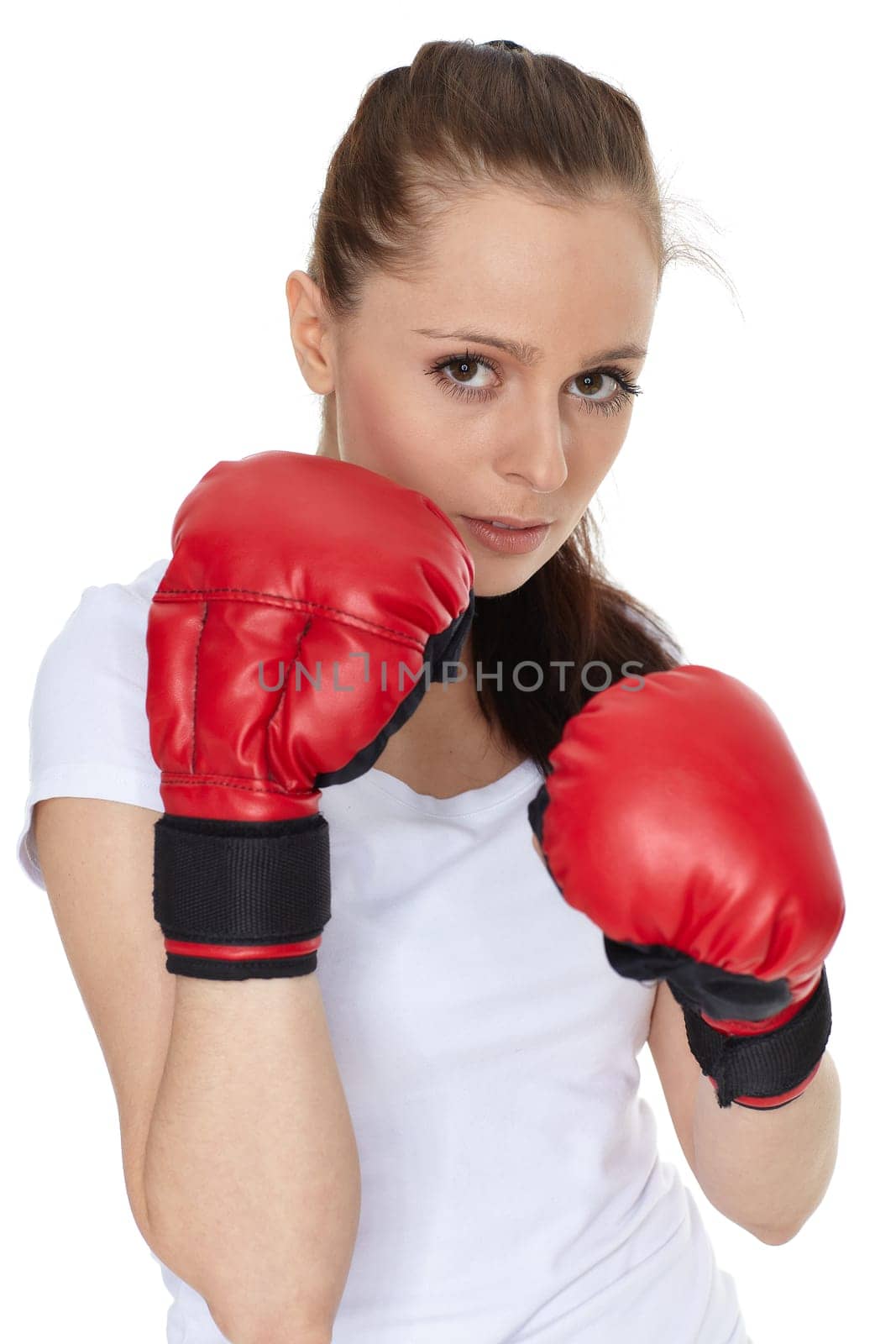 Sporty young woman in red fighting gloves on a white background.