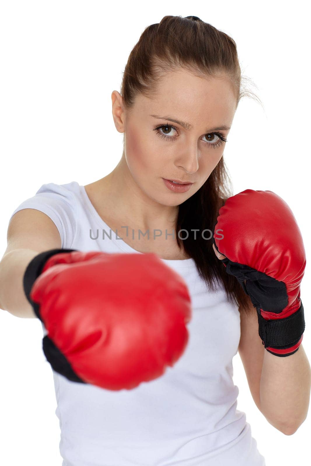 Sporty young woman in red fighting gloves on a white background.