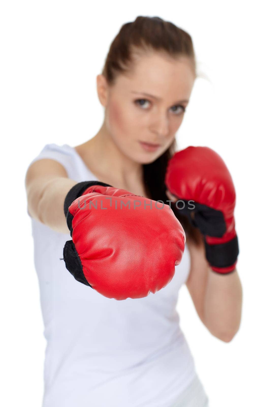 Sporty young woman in red fighting gloves on a white background.